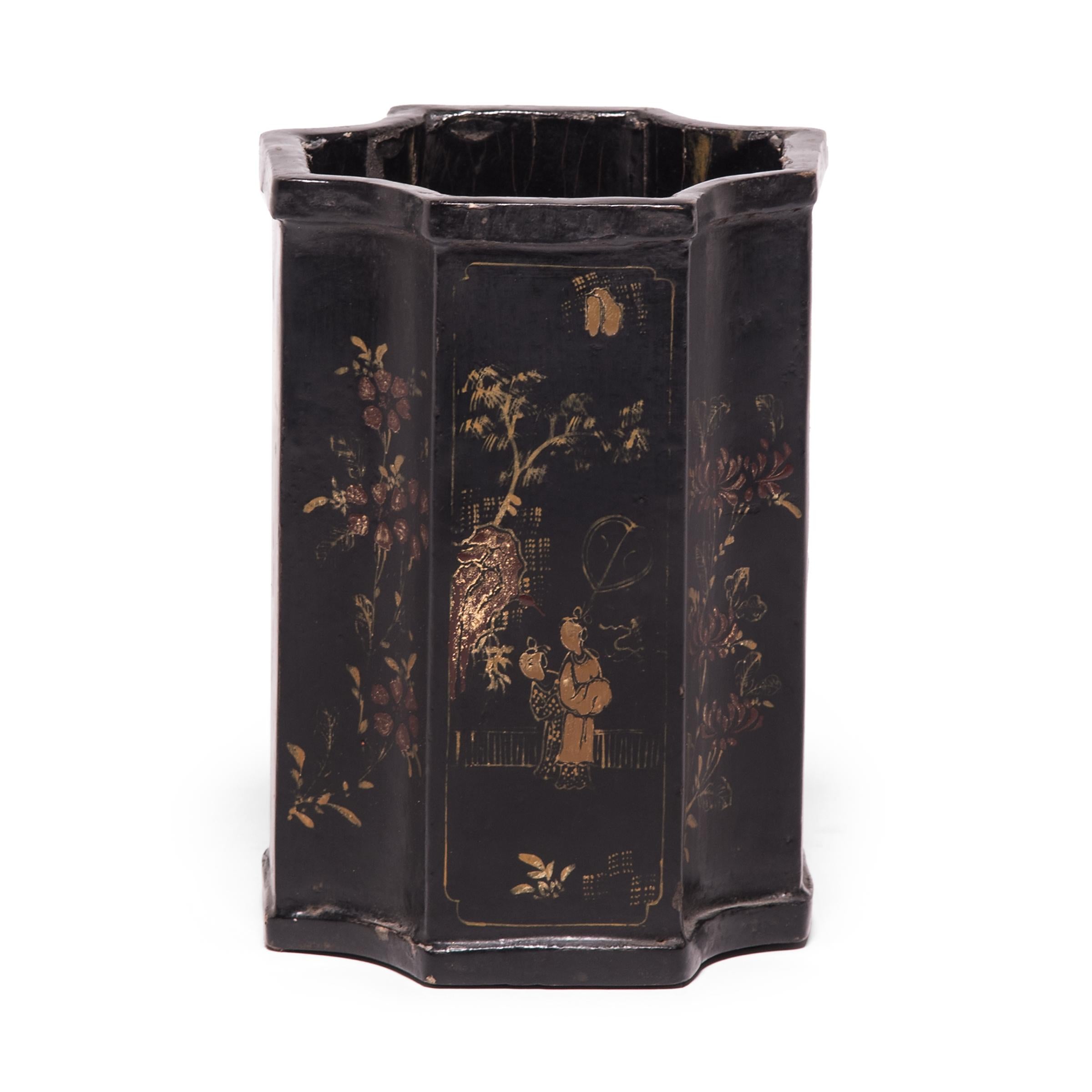 This black lacquered brush pot, which was an essential fixture of a scholar's studio, is hand painted with alternating depictions of garden scenes and flower motifs. These ornate gilt paintings have mellowed beautifully, revealing a depth of