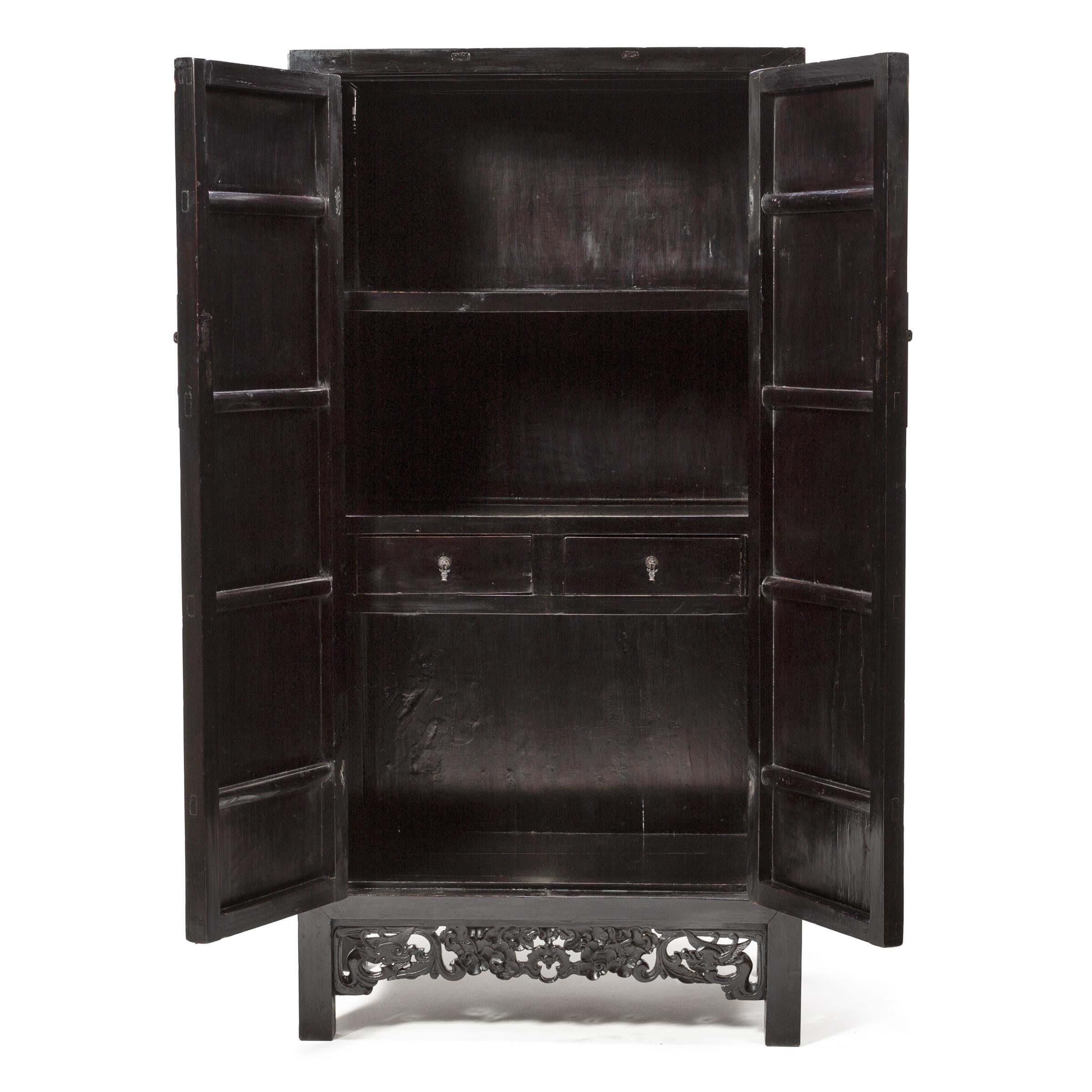 This fantastic mid-19th century cabinet hits all the right notes. Bringing the austere, Minimalist attitude of Ming dynasty design into the Qing dynasty, the artisan woodworkers who created the tall cabinet judiciously introduced intricate