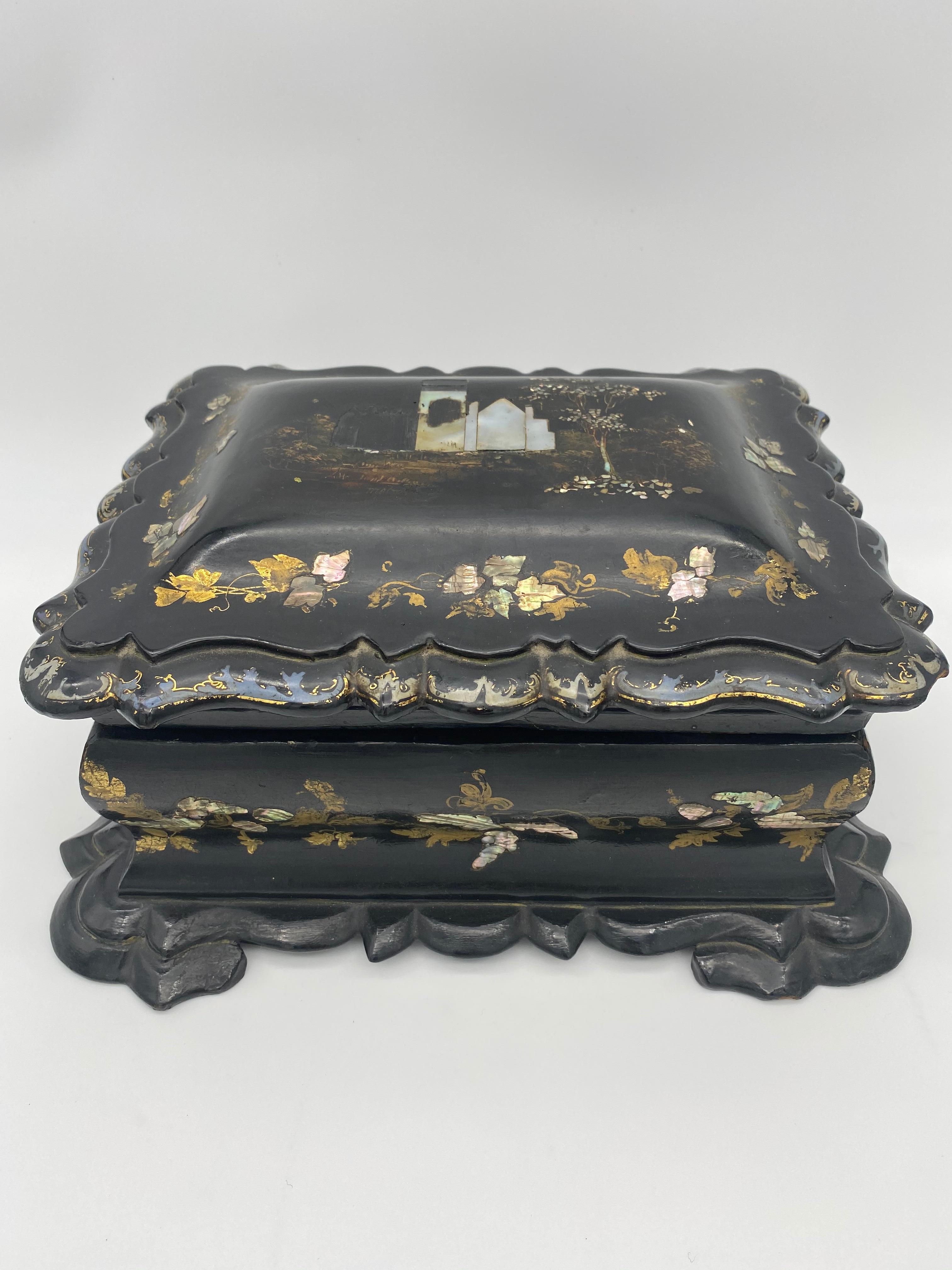 19th century Chinese black lacquer tea caddy from the Qing dynasty decorated all-over with beautiful floral designs.