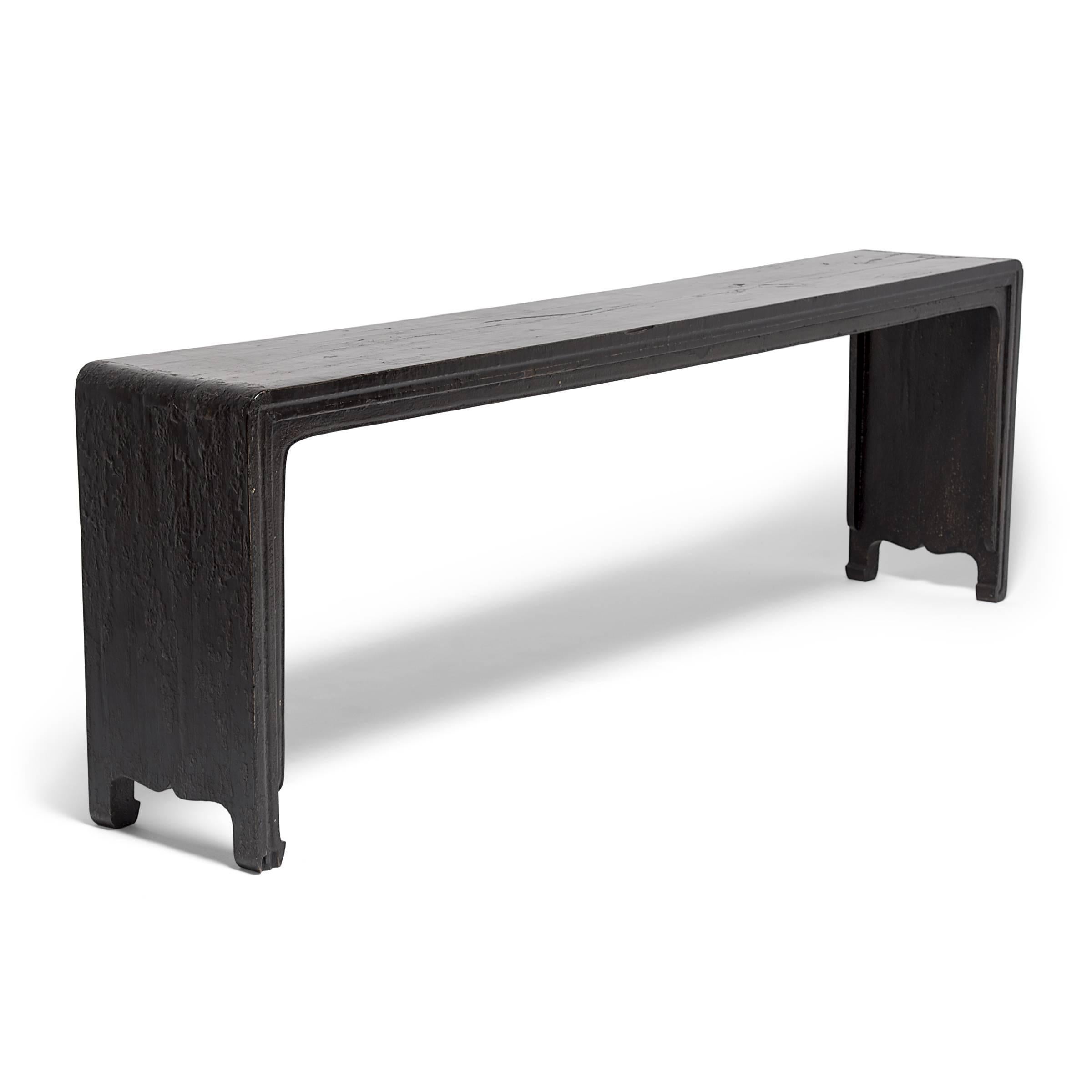 Bringing this altar table’s streamlined shape and waterfall flow into sharp silhouette, the fantastic black lacquer, once glossy and seamless, has aged beautifully with depth and texture that imbue great character. Worn sections now give us a peek