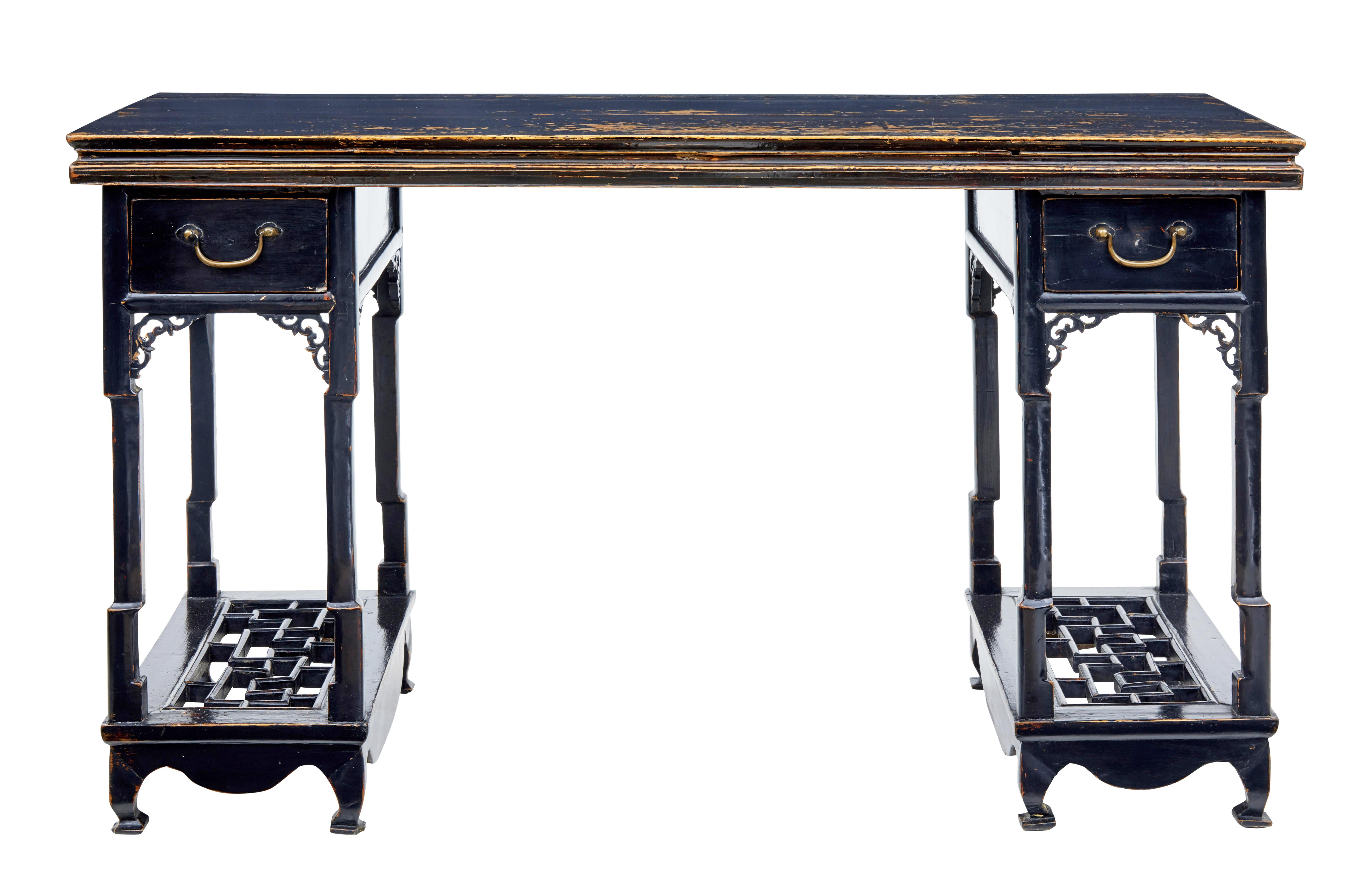 19th century Chinese black lacquered desk, circa 1880.

Comprising of 3 parts, 2 pedestals and top surface. Presented in black lacquer which has worn through.

Now useful as a desk with a drawer in each pedestal and lower pierced carved shelf.