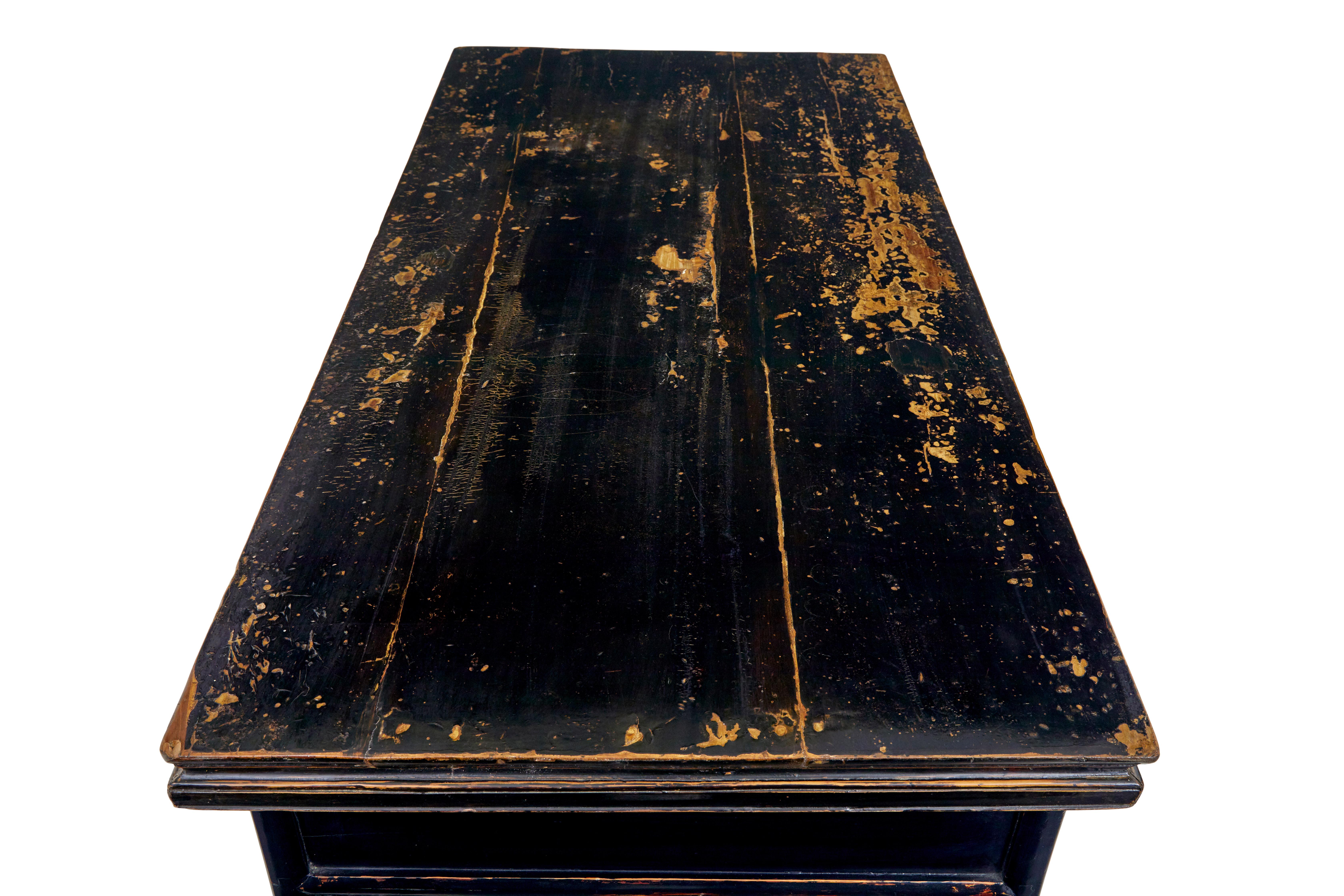 19th century Chinese black lacquered desk circa 1880.

Comprising of 3 parts, 2 pedestals and top surface.  Presented in black lacquer which has worn through.

Now useful as a desk with a drawer in each pedestal and lower pierced carved shelf. 