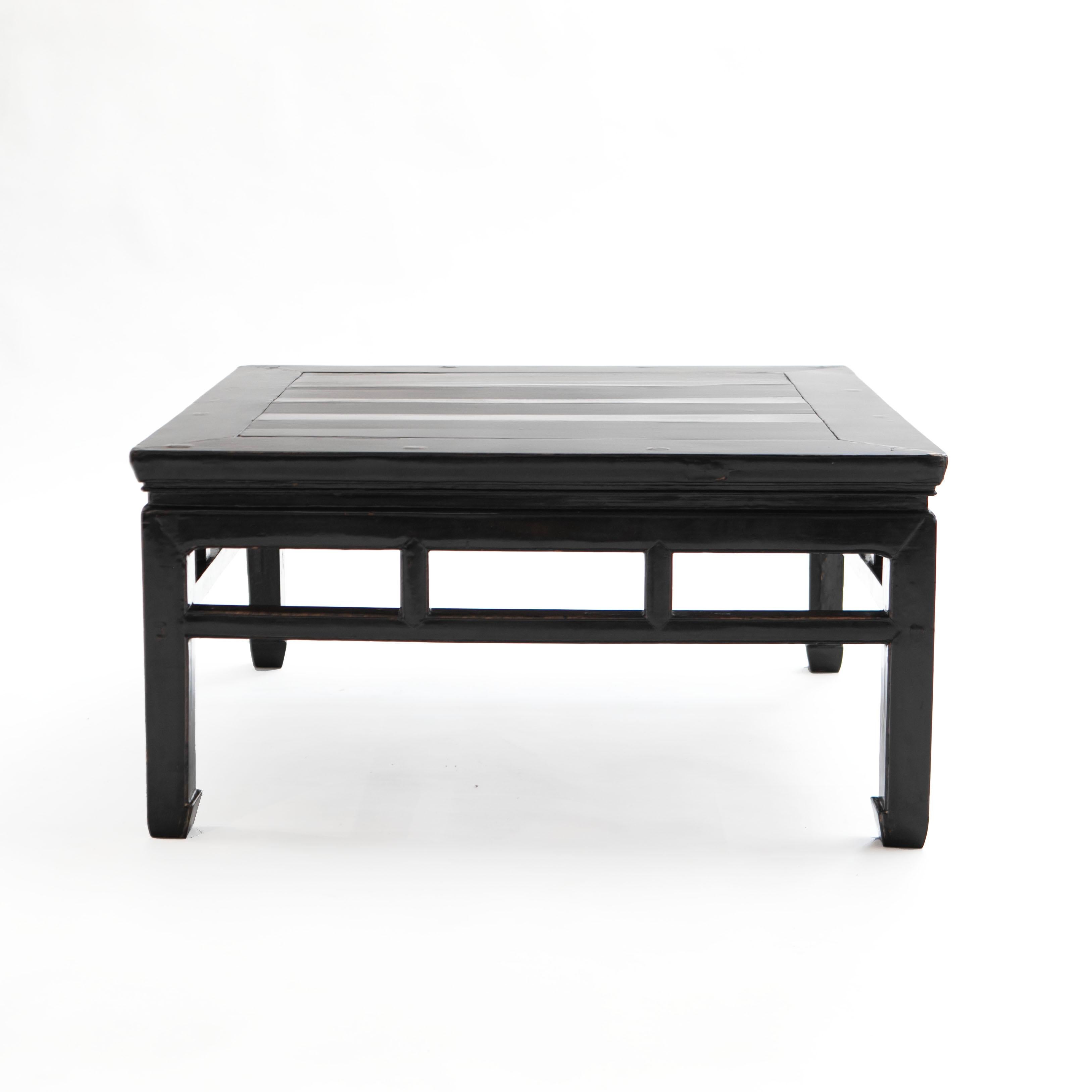 A Chinese Ming style coffee table crafted in elm wood with original black lacquer and natural patina, enhanced with a clear lacquer surface finish.

Jiangsu Province, China 1860-1870