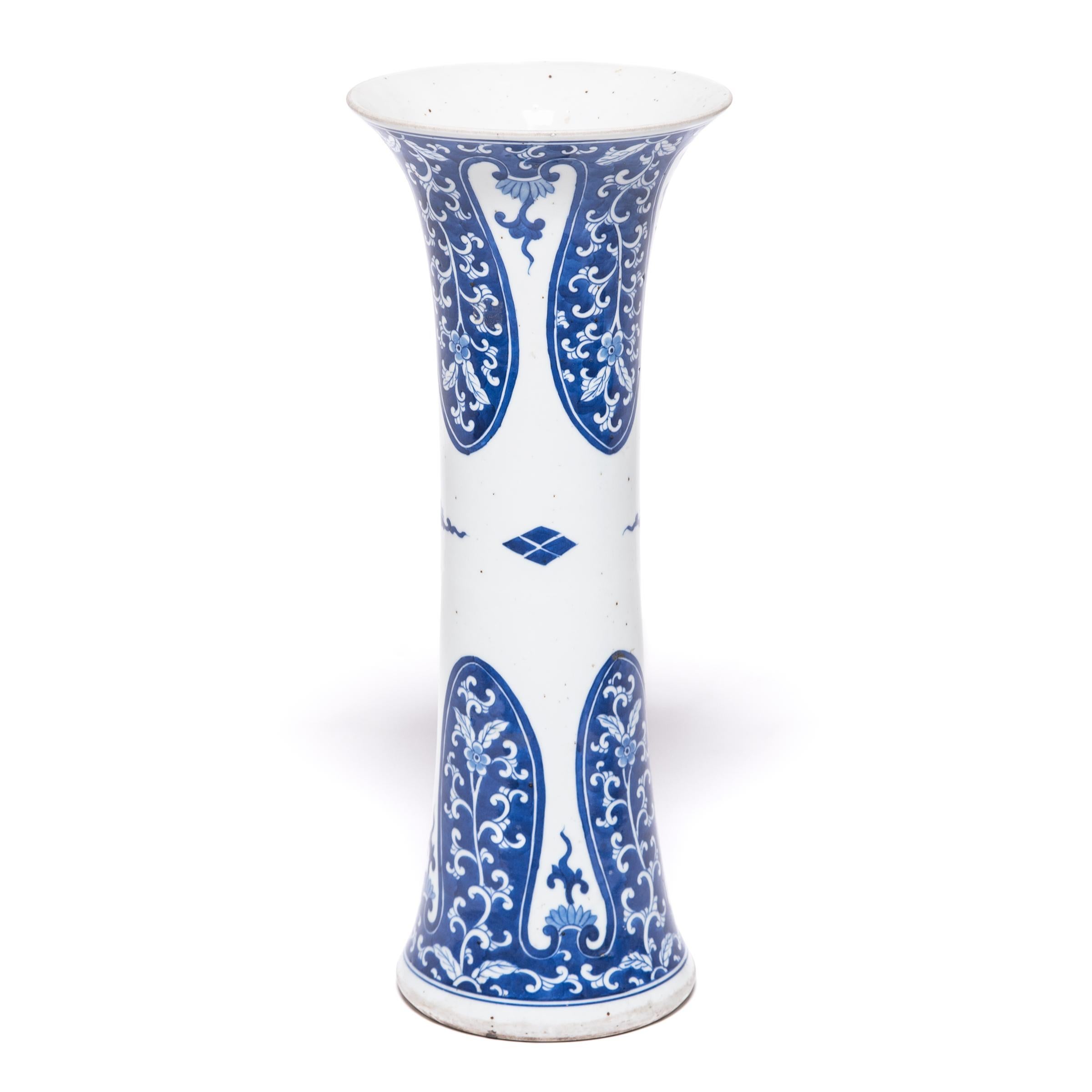 Originally cast in bronze, the gu vase form dates back nearly three thousand years. Characterized by a slender body and flared mouth, gu vases were traditionally used for drinking wine or presenting ritual offerings. Crafted of porcelain, this