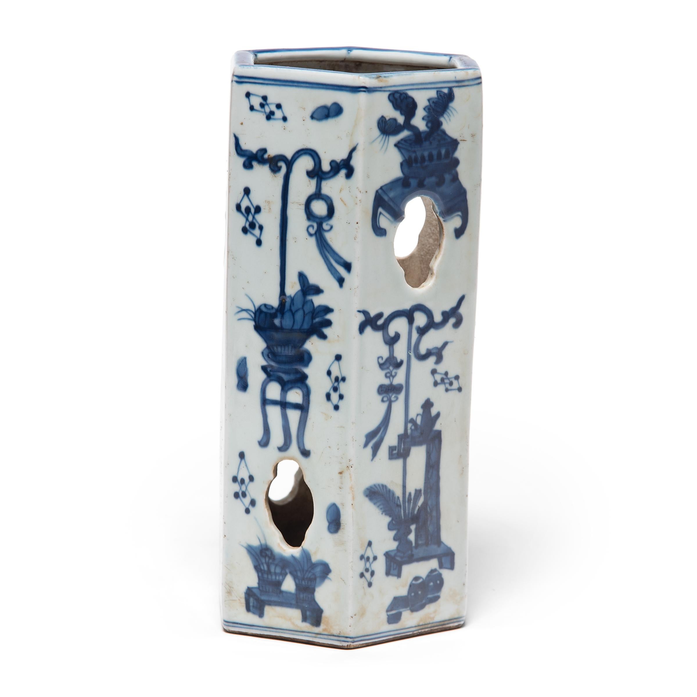 Accented with quatrefoil cutouts to provide airflow, this 19th century porcelain hat stand was once used by a Qing-dynasty gentleman to display his cap while it wasn't being worn. The six-sided hat stand is painted with fanciful arrangements of