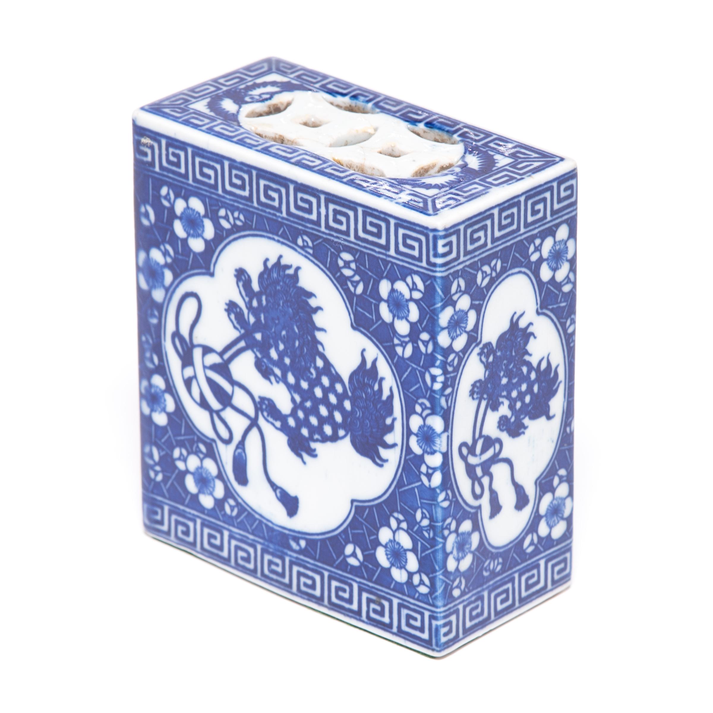 In order to keep her elaborate hairstyle intact while sleeping, a well-to-do Qing-dynasty woman once used this ceramic box as a pillow. Lavishly decorated in the traditional blue-and-white style, the headrest features a guardian lion in pursuit of