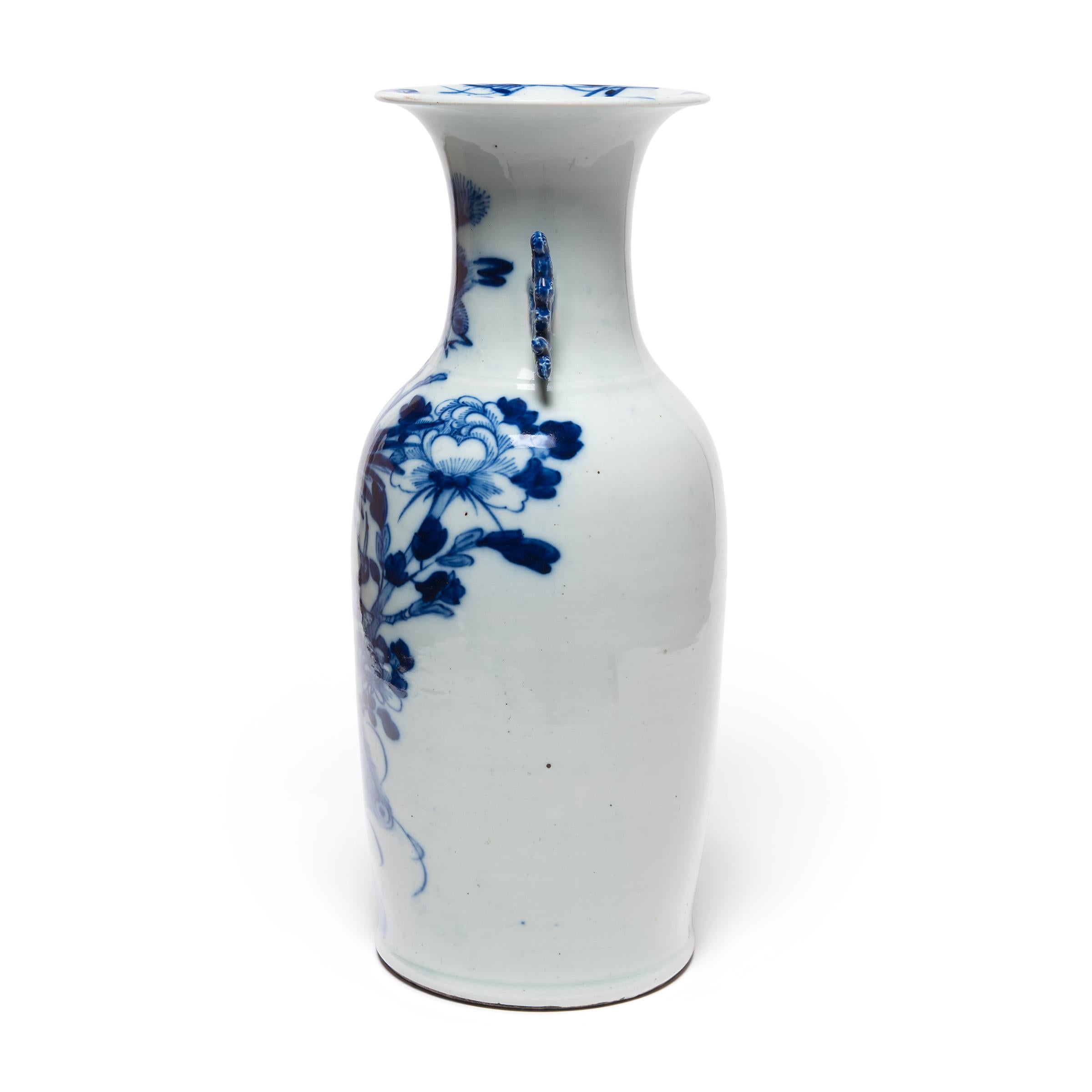 This 19th century porcelain vase is an exquisite example of Chinese blue-and-white pottery. The vase is expertly formed with thin walls, widening to a flared lip and flanked by two molded scroll handles. Painted with richly saturated cobalt