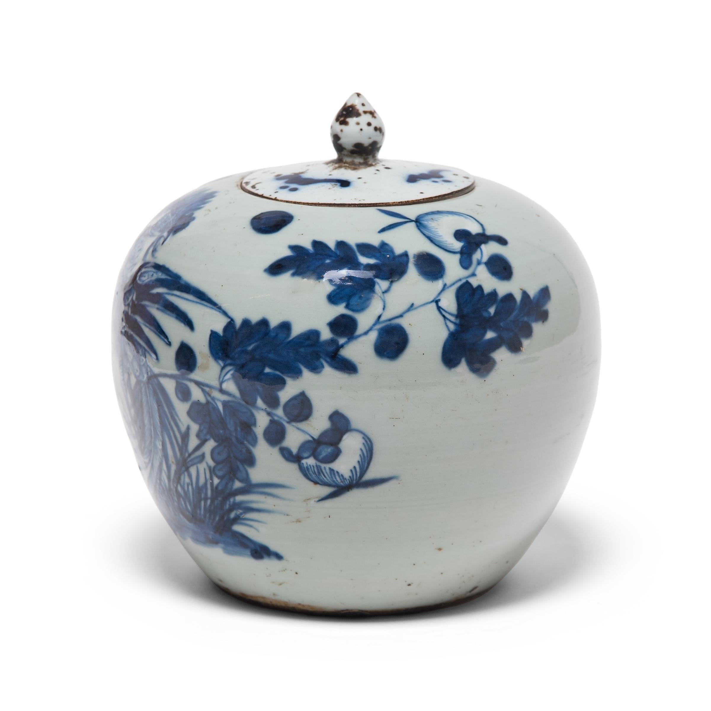 This 19th century blue-and-white ginger jar is defined by its thin walls, round body, and delicate lid topped with a bud-form handle. Painted with expressive brushwork, the jar is festooned with peony blossoms, emblems of spring time and feminine