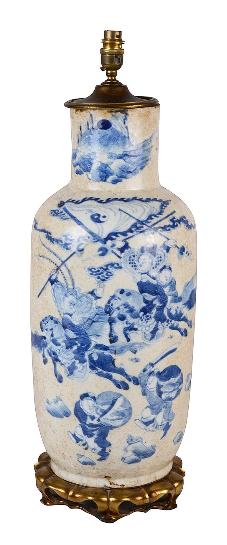 An impressive, good quality late 19th Century Chinese export blue and white crackleware vase / lamp. Having wonderful hand painted scenes of soldiers on horseback and running holding shields and swords.
Mounted on a gilded ormolu pierced stand in