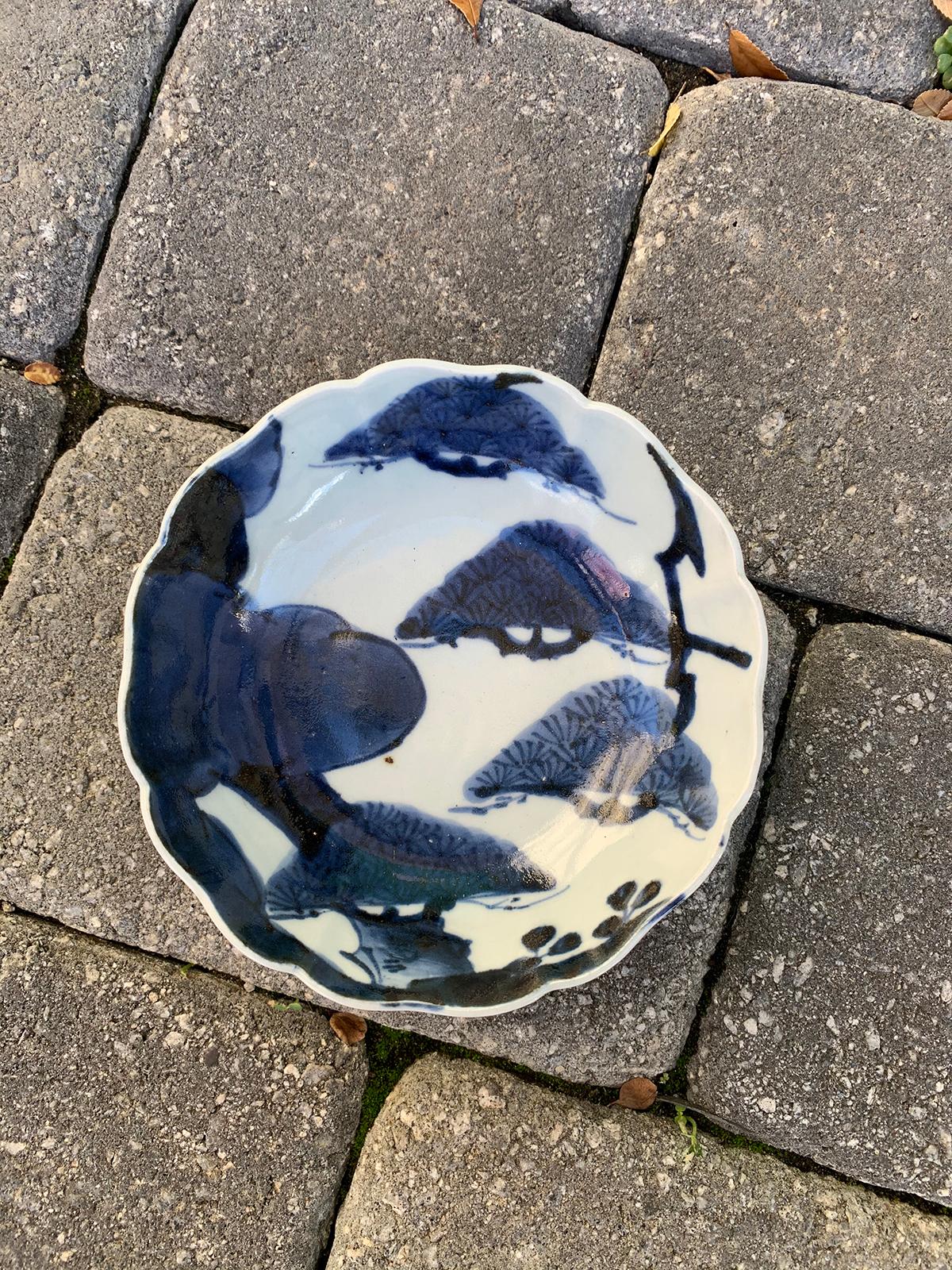 19th century Chinese blue and white porcelain bowl with scalloped edge and bonsai tree pattern.