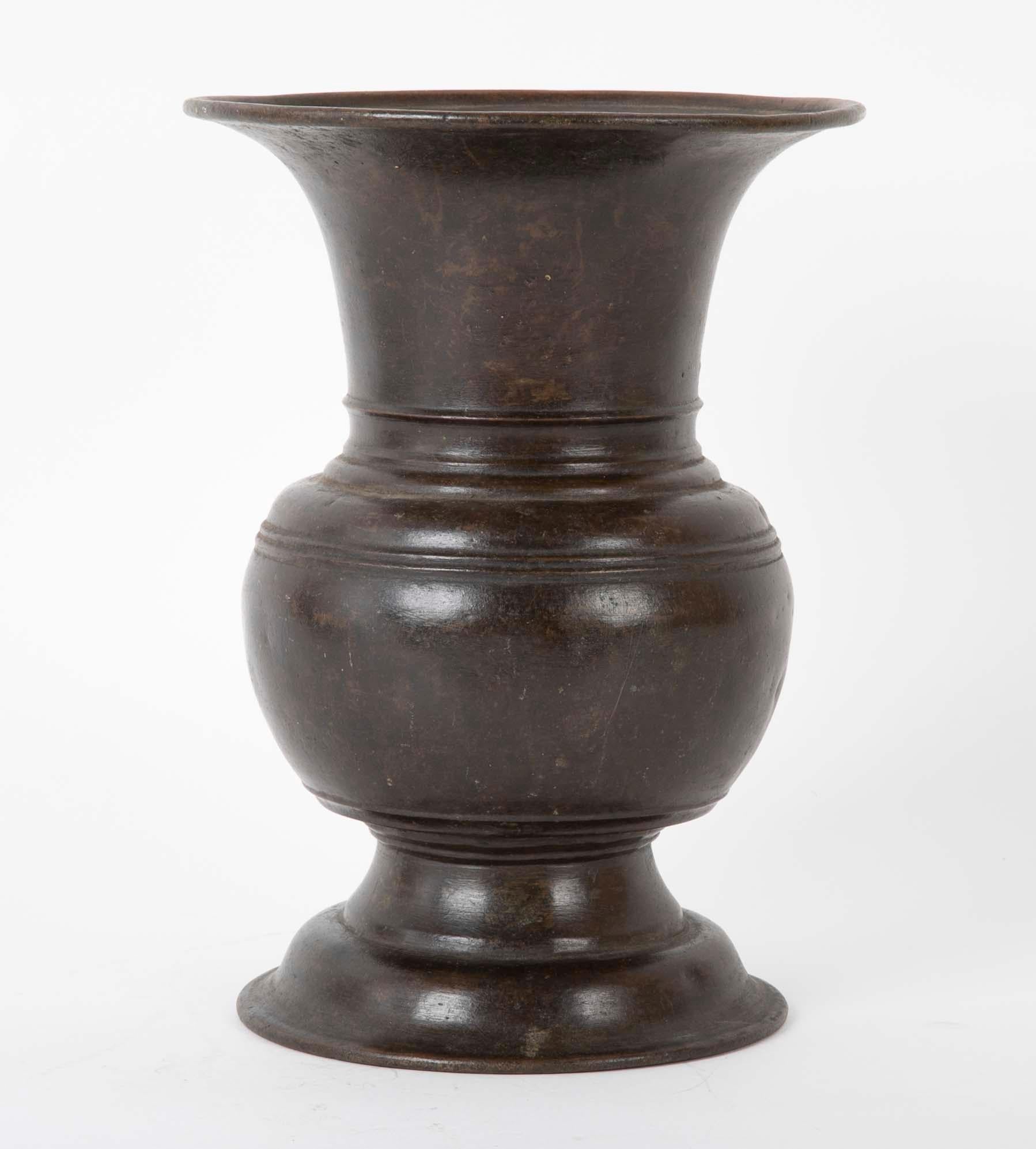 Chinese bronze urn with chocolate brown patina, handsome form with flaring base and top supporting a bulbous center. The classic profile of this piece will make a stunning vase.