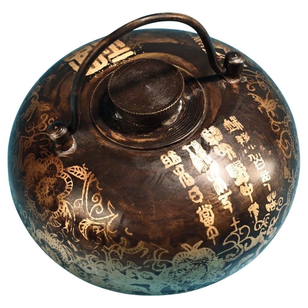 Step back into the elegance of 19th-century China with this Bronze Warm Hand and Foot Pot, adorned with beautifully detailed auspicious paintings. This exquisite artifact reflects the era’s artistry and functionality, serving as a warming vessel for
