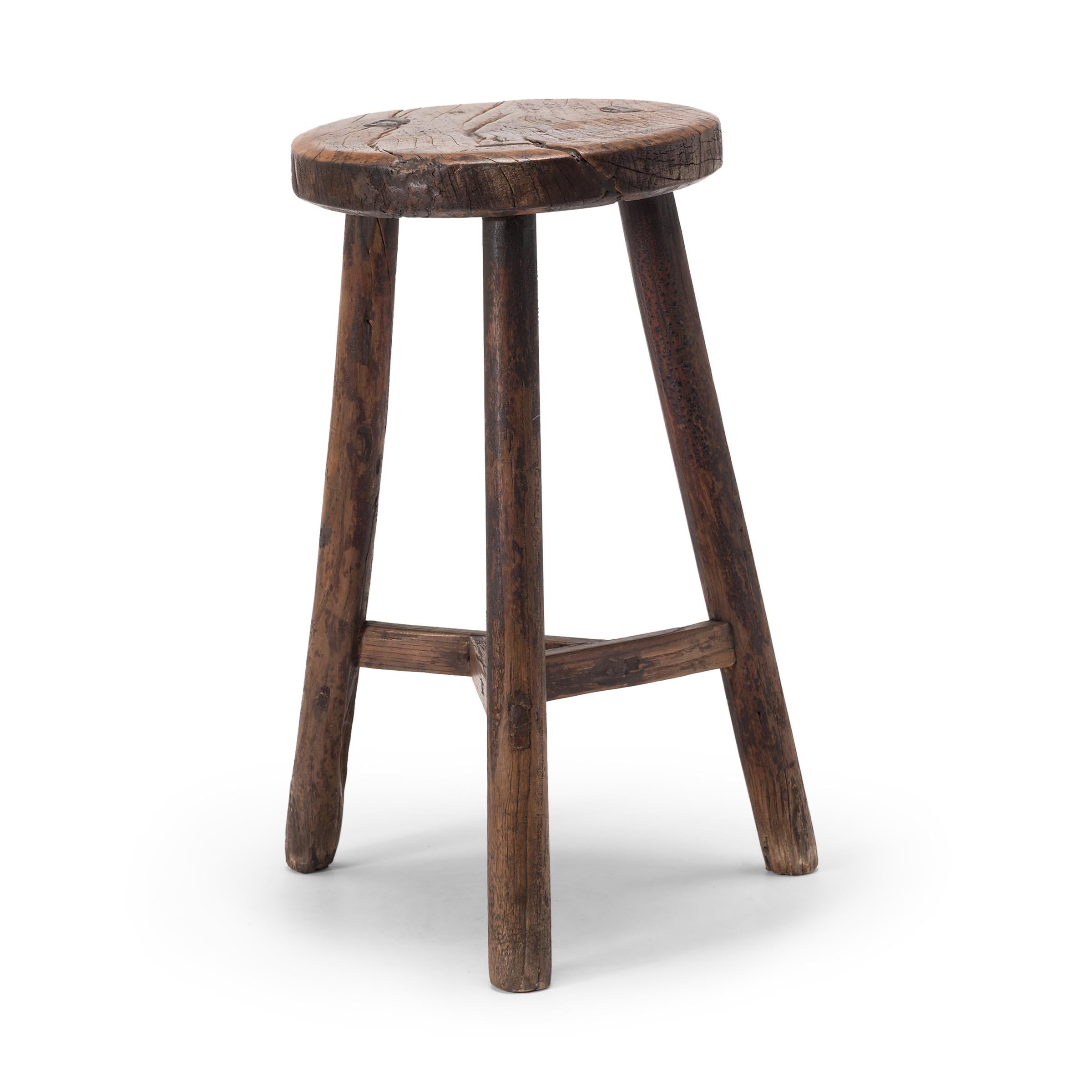 This 19th century stool from China's Shanxi province charms with its simple form and dark finish. The stool's round seat is cut from burled elmwood and embraces the notion of 