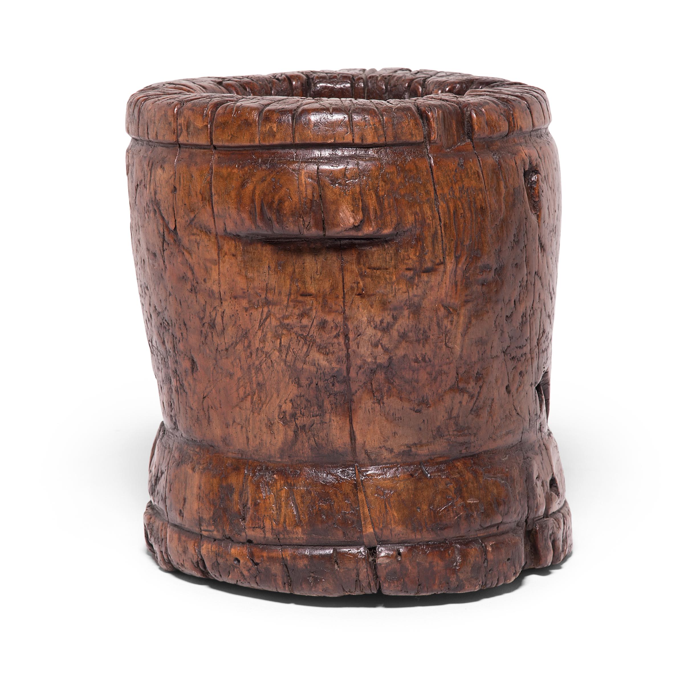 This 19th century sculptural container was originally used as a mortar, possibly in a Chinese apothecary to grind herbal medicines. Marked by petite butterfly joints and textured by the natural knots and crevices of northern elmwood, this wooden