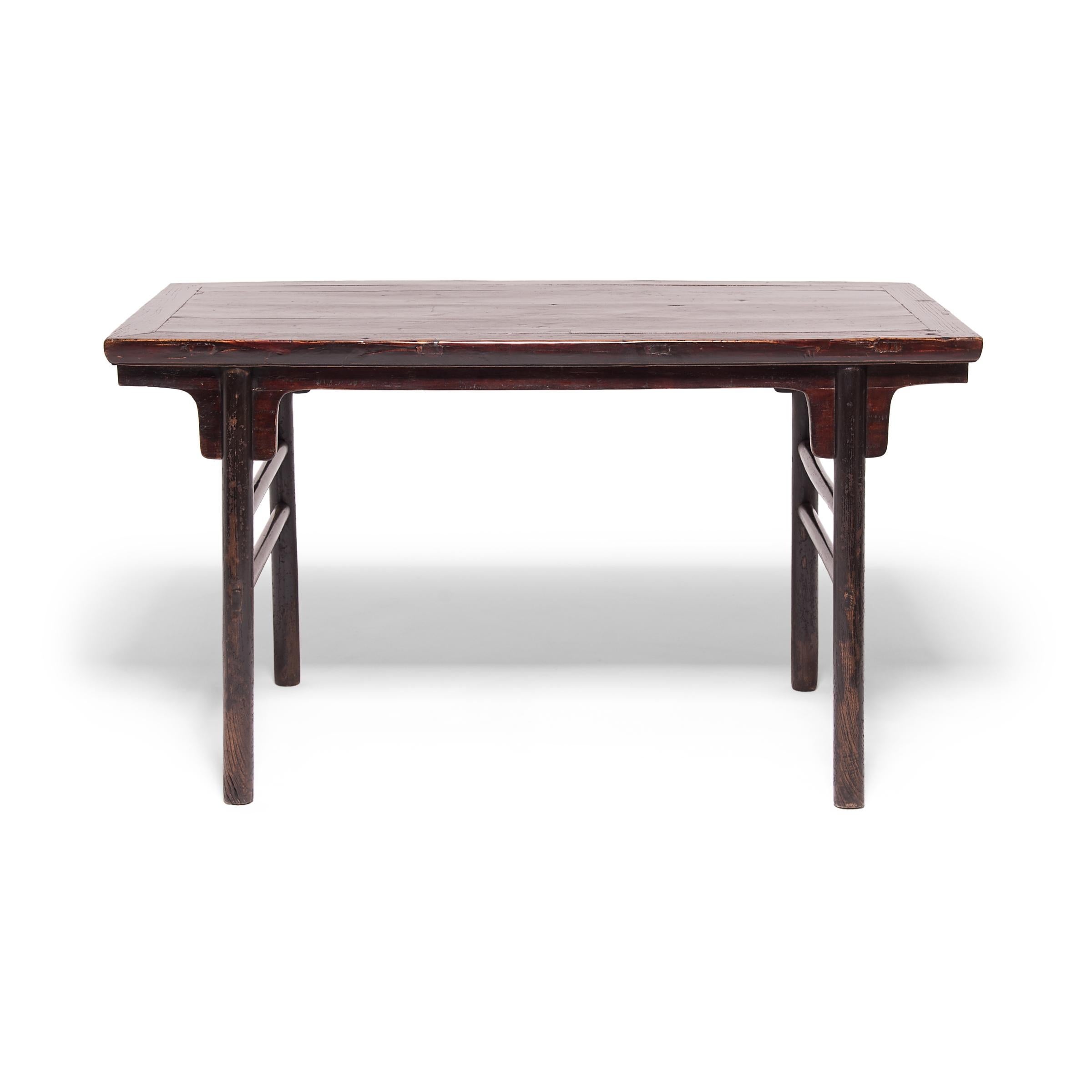 This calligraphy table, like all the highest quality pieces of Chinese furniture, follows the timeless principles of Chinese architectural design and construction techniques. It has bold strong lines, limited ornamentation, and simple double