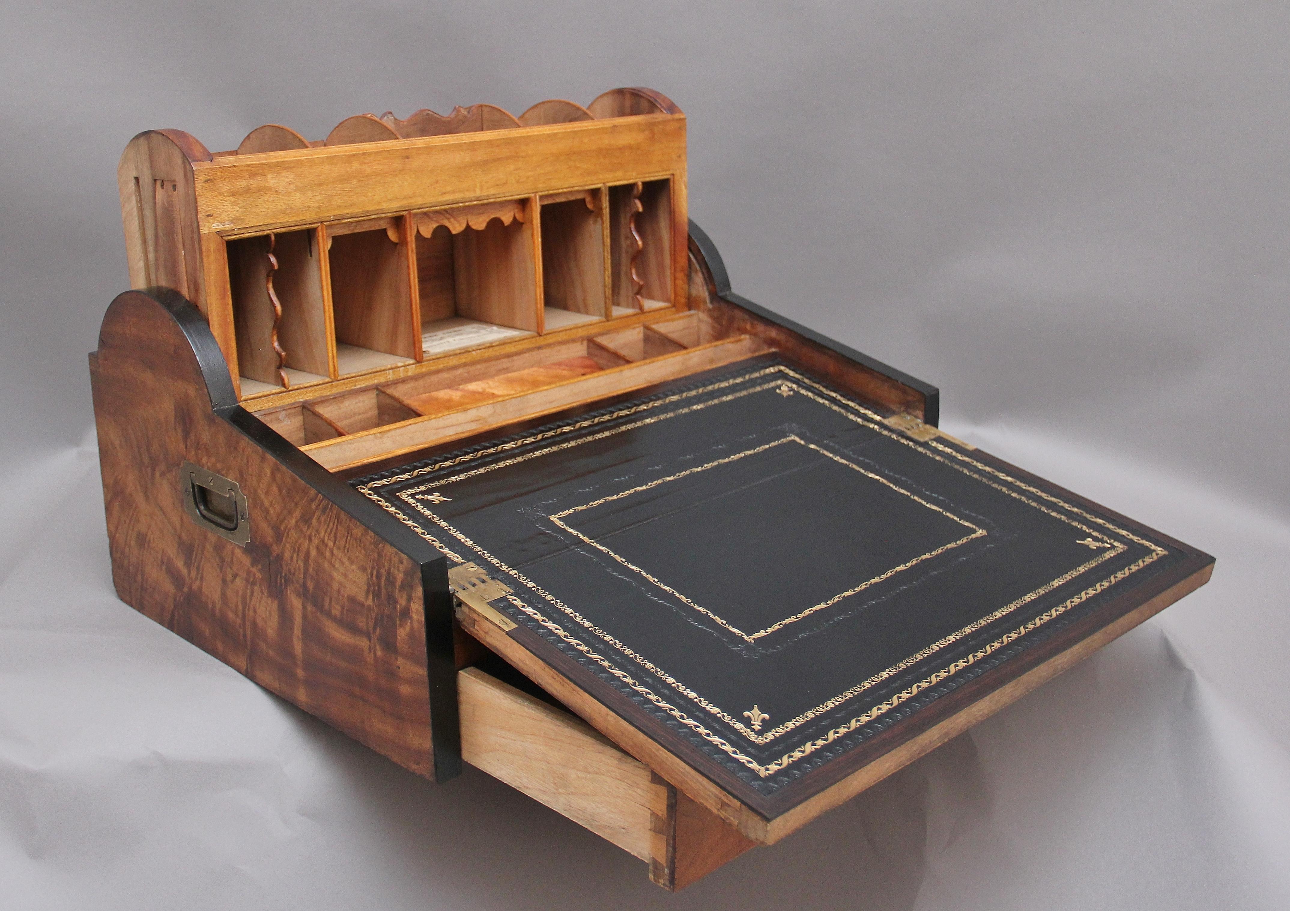 19th century Chinese camphor wood and ebonised writing slope of exceptional quality, having a drawer to the front which when pulls out opens the tambour shutter on top to reveal a lift up stationary rack with various sized compartments, in the