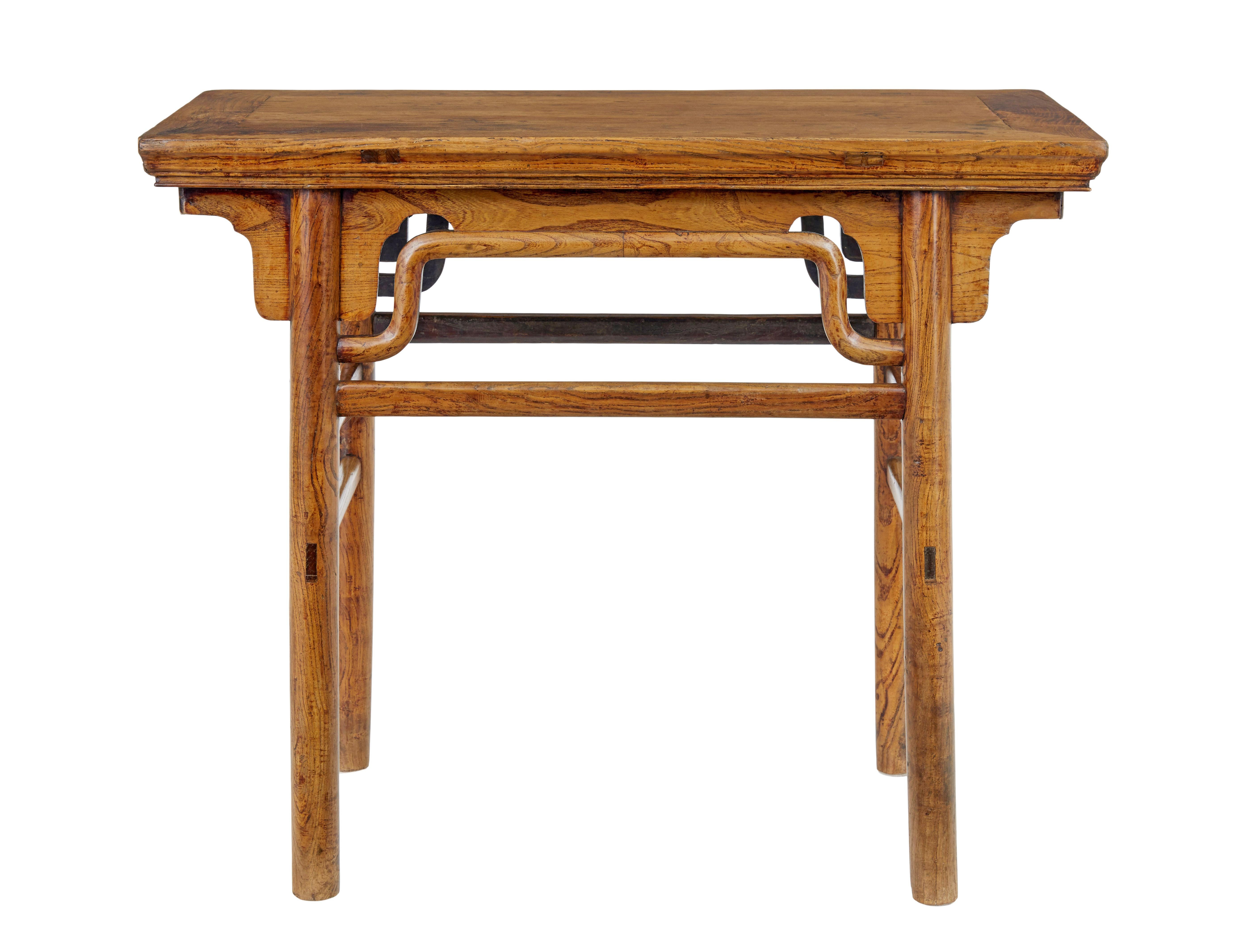19th century Chinese carved elm occasional table, circa 1870.

Qing period table with good colour and patina.

Rectangular top and shaped elm decoration below the freize. Standing on rounded legs united by stretchers.

Areas of surface fading