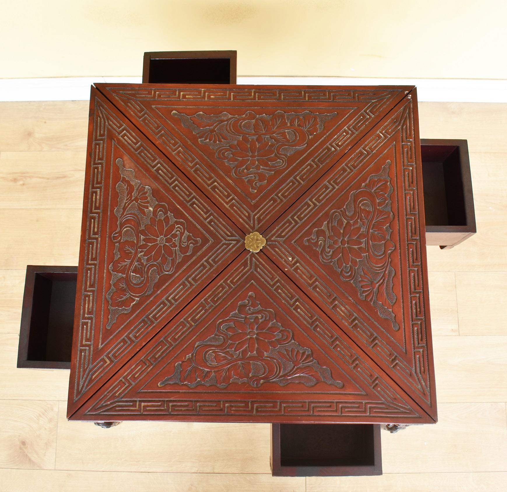 For sale is a good quality 19th century Chinese carved hardwood envelope card table, opening to reveal a green baize playing surface on stylized dragon supports, united by a carved stretcher. This piece is in good, original condition, having only