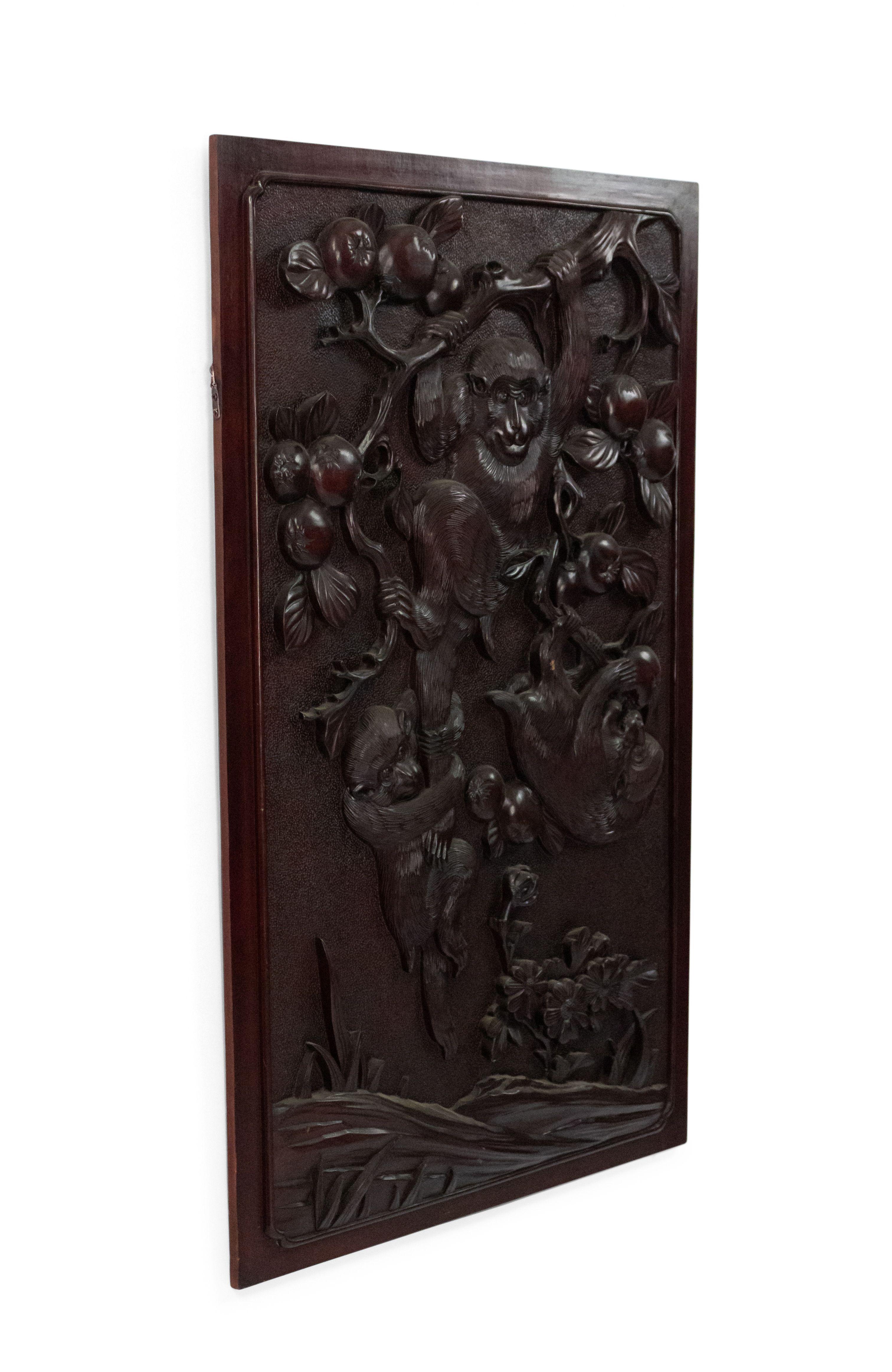 Chinese 19th century carved wall plaque with monkeys playing in trees with fruit (finished on back with bamboo trees).
 
