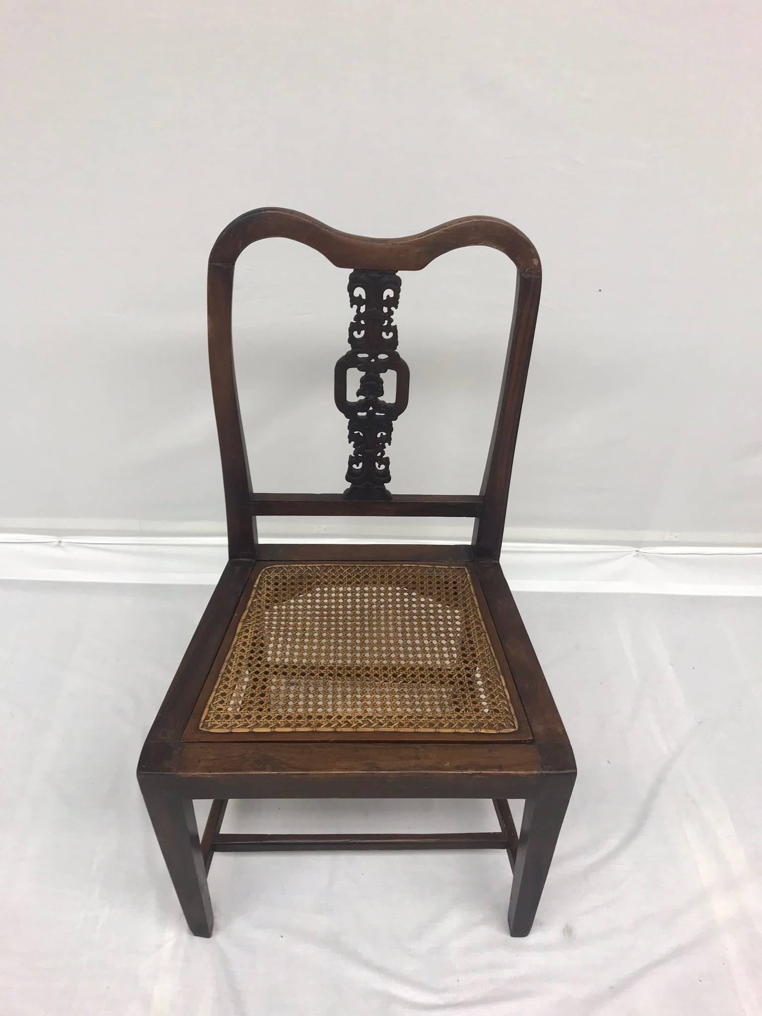 An antique wood chinoiserie hall or occasional chair with delicious carved detailing upon the back and a caned seat. Original finish.
Seat dimensions: 17