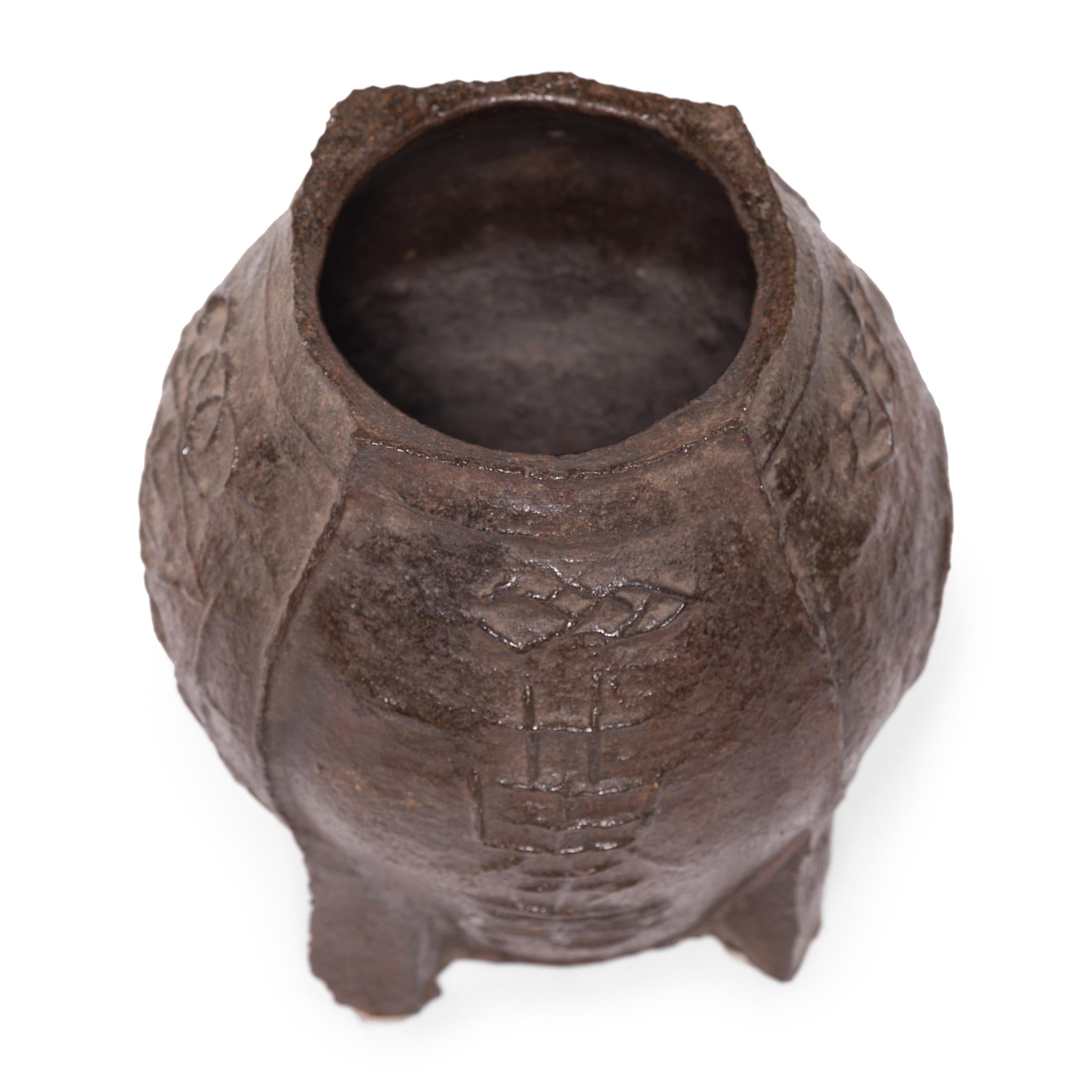 Cast in iron with a raised design, this vintage mortar was originally used in a traditional apothecary to create herbal medicines. The swelling shape allowed free movement of a pestle to effectively grind, mash, and macerate herbs and seeds in