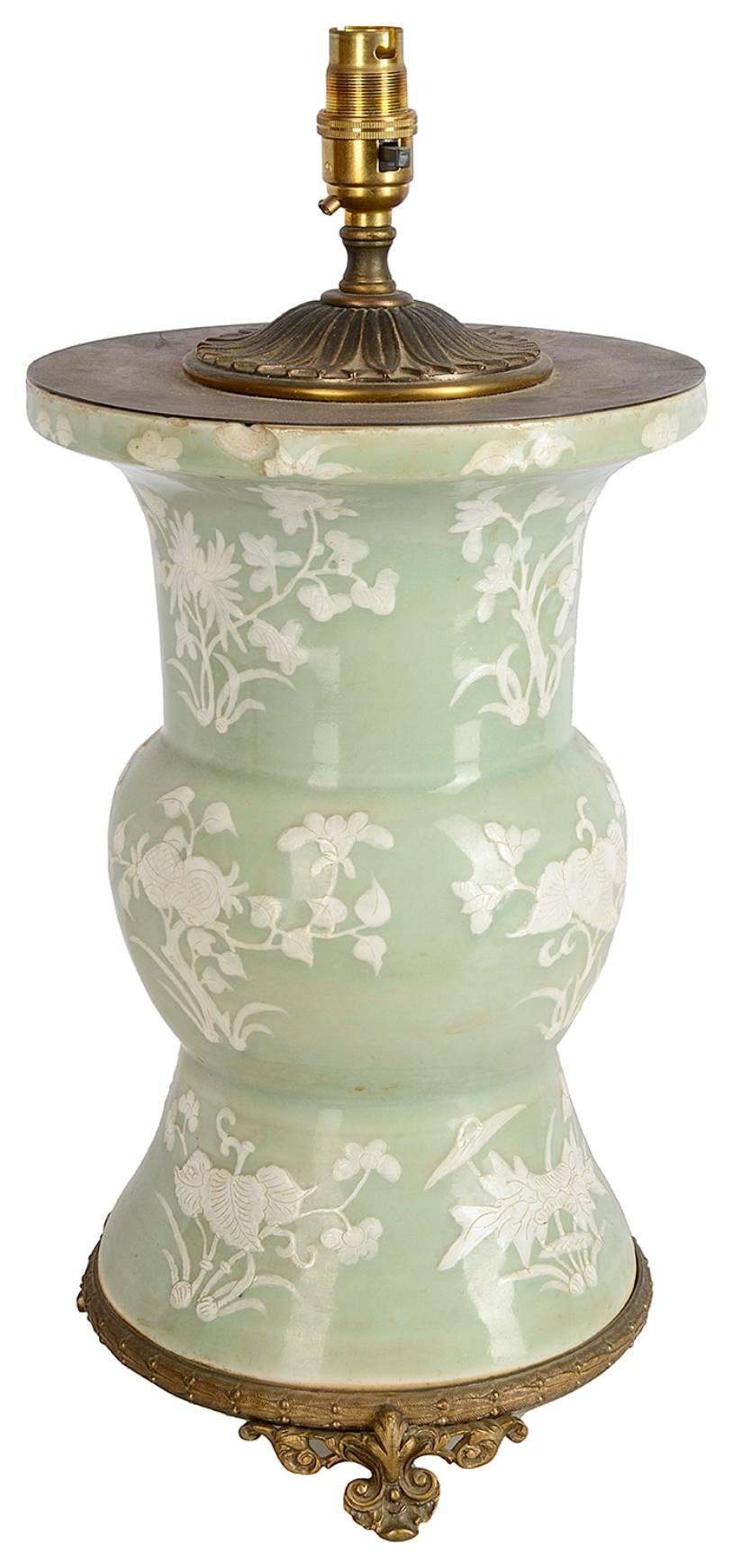 A good quality 19th century Chinese celadon vase or lamp, having floral decoration and mounted in an ormolu base and a top.
