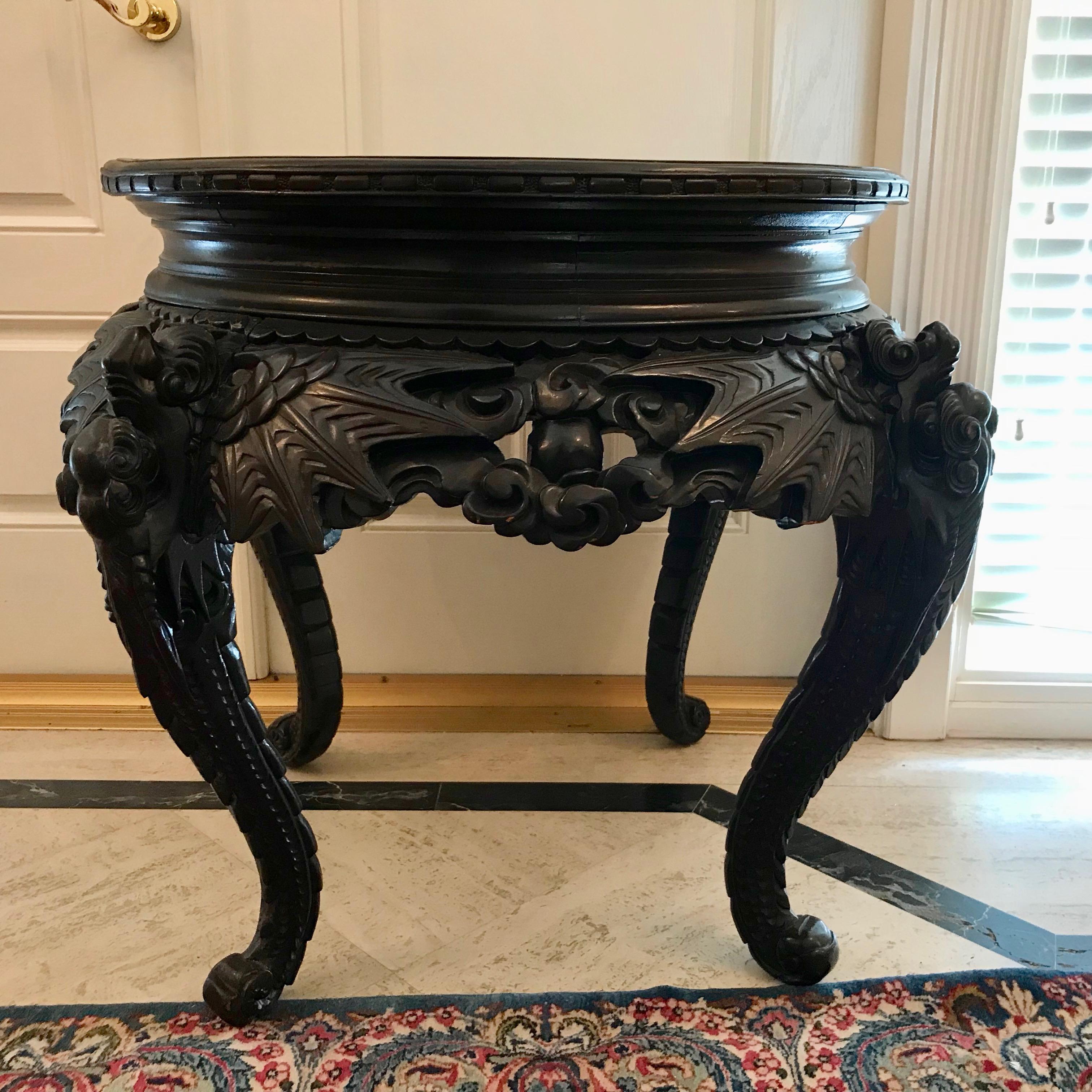 Dramatic in form and scale. The table is fashioned with a generously scaled pierced carved apron and appointed with large figures of bats with wings
spread across the apron