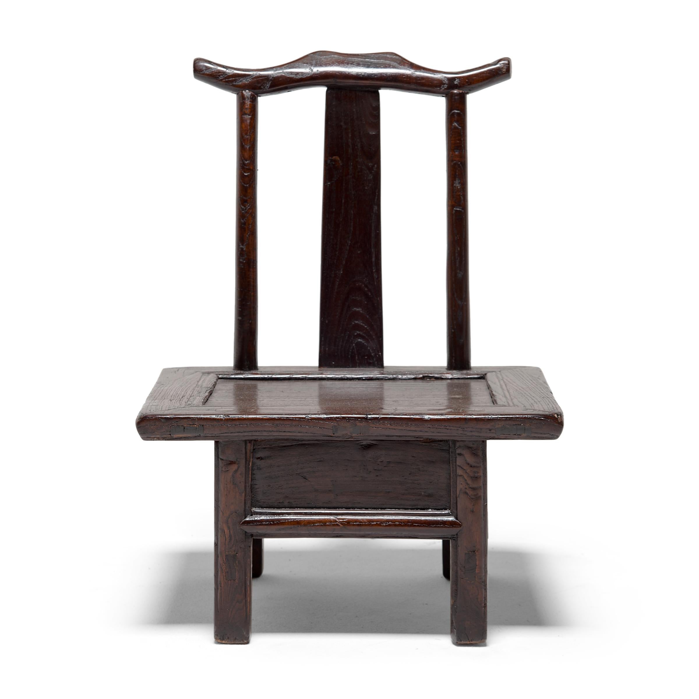 This petite 19th century chair from northern China is a children's chair designed to resemble a 