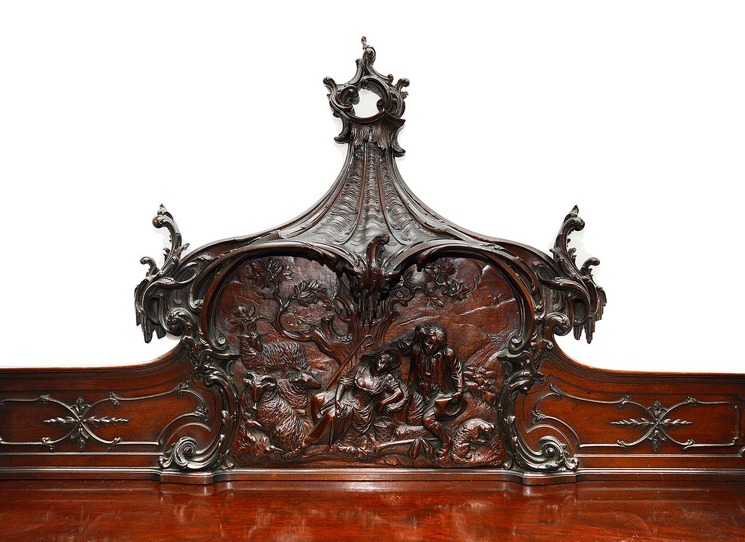 A Magnificent Chinese Chippendale style mahogany sideboard, having carved scrolling pagoda influenced pedestals, a central hand carved scene of a Sheppard and Shepherdess resting under a tree with their flock. Wonderful blind fretwork and scrolling