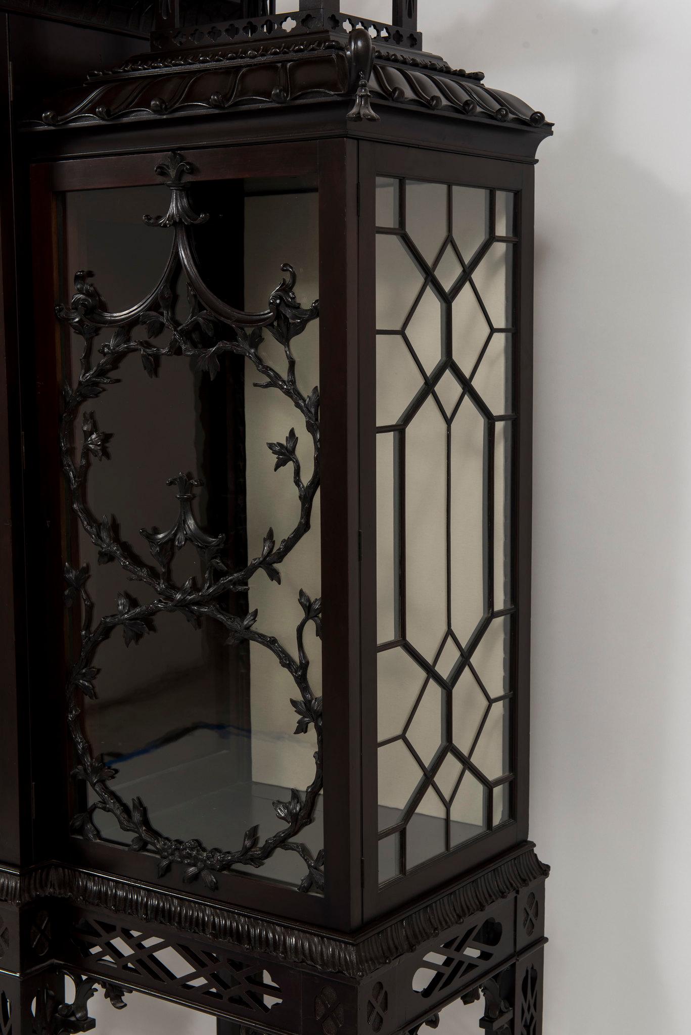 A stunning and rare 19th Century English Chinese Chippendale pagoda cabinets. This highly stylized hand carved mahogany cabinets features, glass shelving, pagoda gabled roofs, classic Chippendale fret work, and branch vined glazing bars in a trellis