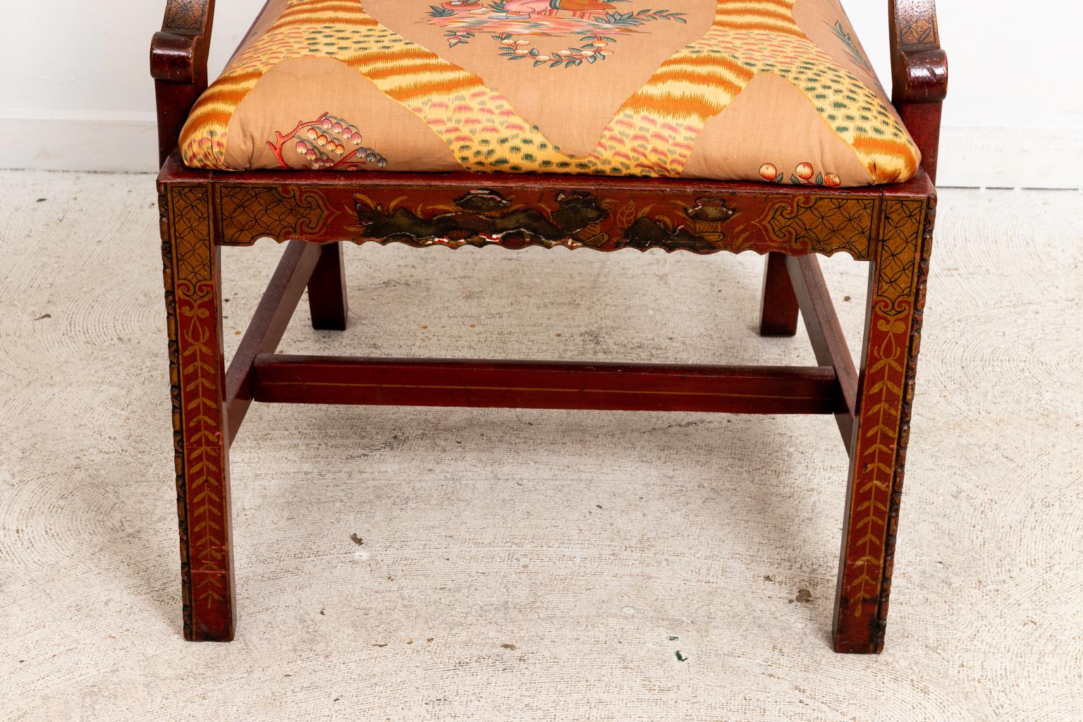 Circa 19th century Chinese Chippendale style armchair with upholstered seat and bottom stretchers. The piece also features a pierced Chinese Chippendale style fretwork panel on the seatback and painted foliage motifs throughout the top rail, ears,