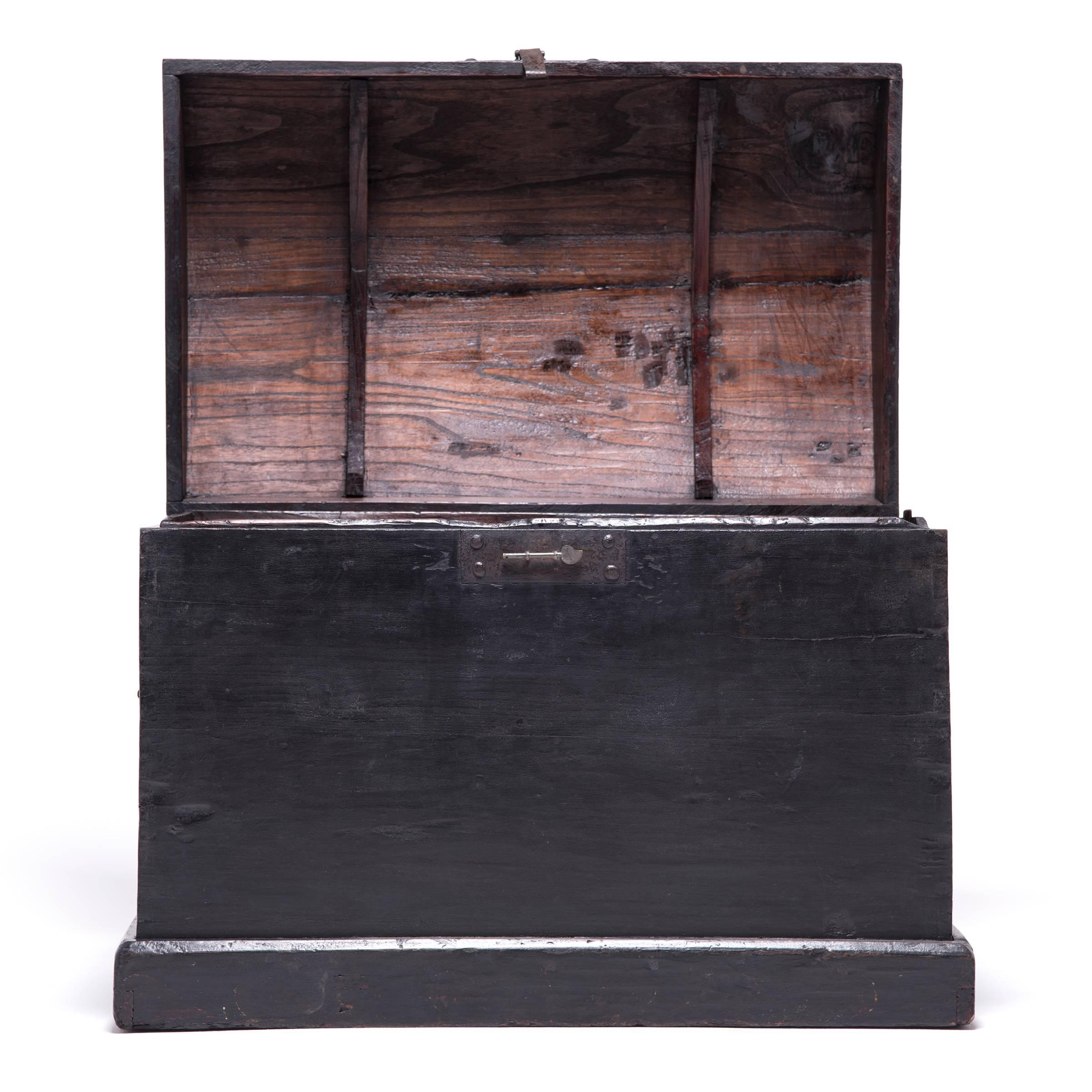 This rustic pine trunk dating from the Qing dynasty projects quiet harmony and balance. Simple in design and bare of ornament except for its brass hardware, the trunk epitomizes the austerity of classical Chinese furniture design. Made in Hebei