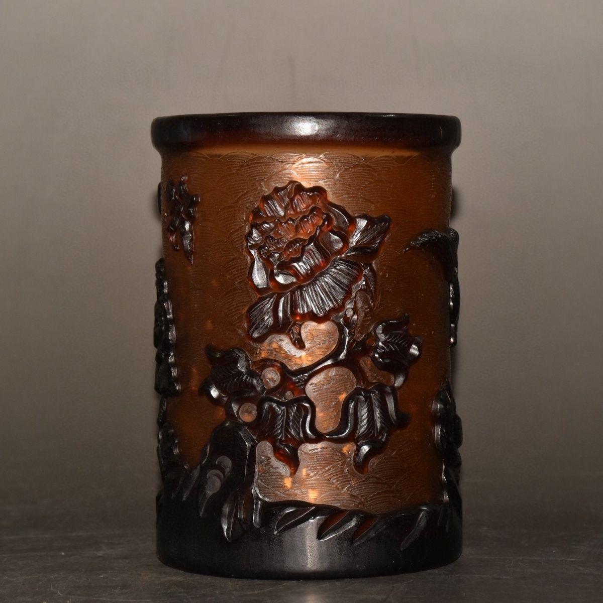 This 19th Century Chinese Colored Glaze Pen Pot features exquisite hand-carved birds and flowers, showcasing the intricate craftsmanship of the period. The vibrant colored glaze accentuates the natural beauty of the floral and avian designs, making