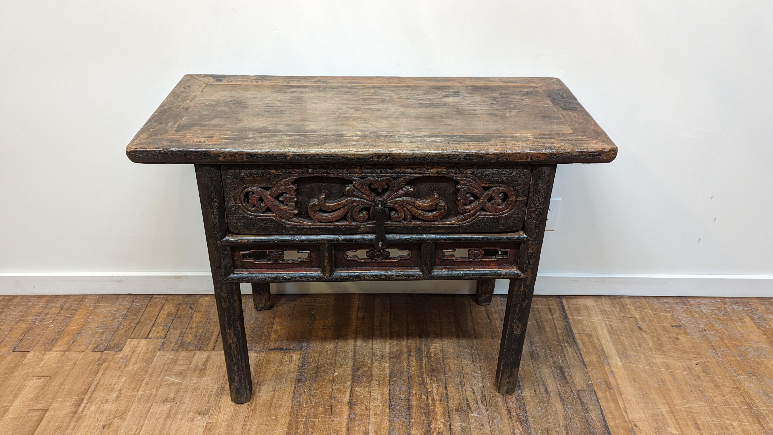 Early 19th century Chinese Console.  Amazing 19th century Console table.  Spectacular patina, rustic with alligatored black and red lacquer remnants to most of the structure.   Wonderful foliate carving to the front drawer plate with intersecting