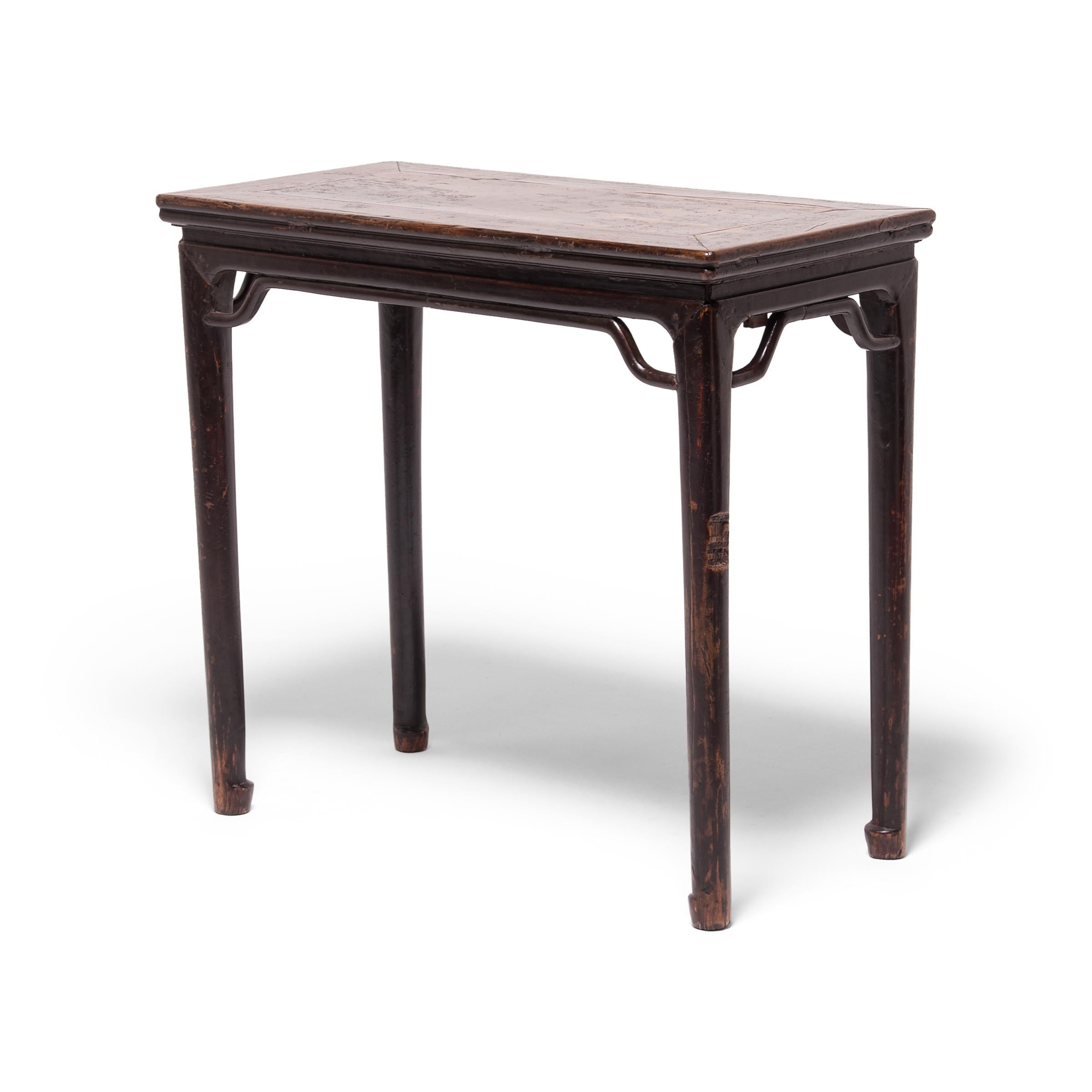 Crafted of dark brown walnut, a wood prized for its open-grained texture and warm tones, this 19th-century wine table expresses the refined forms of Ming-dynasty furniture. With clean lines and a dark lacquer finish, the table's streamlined form