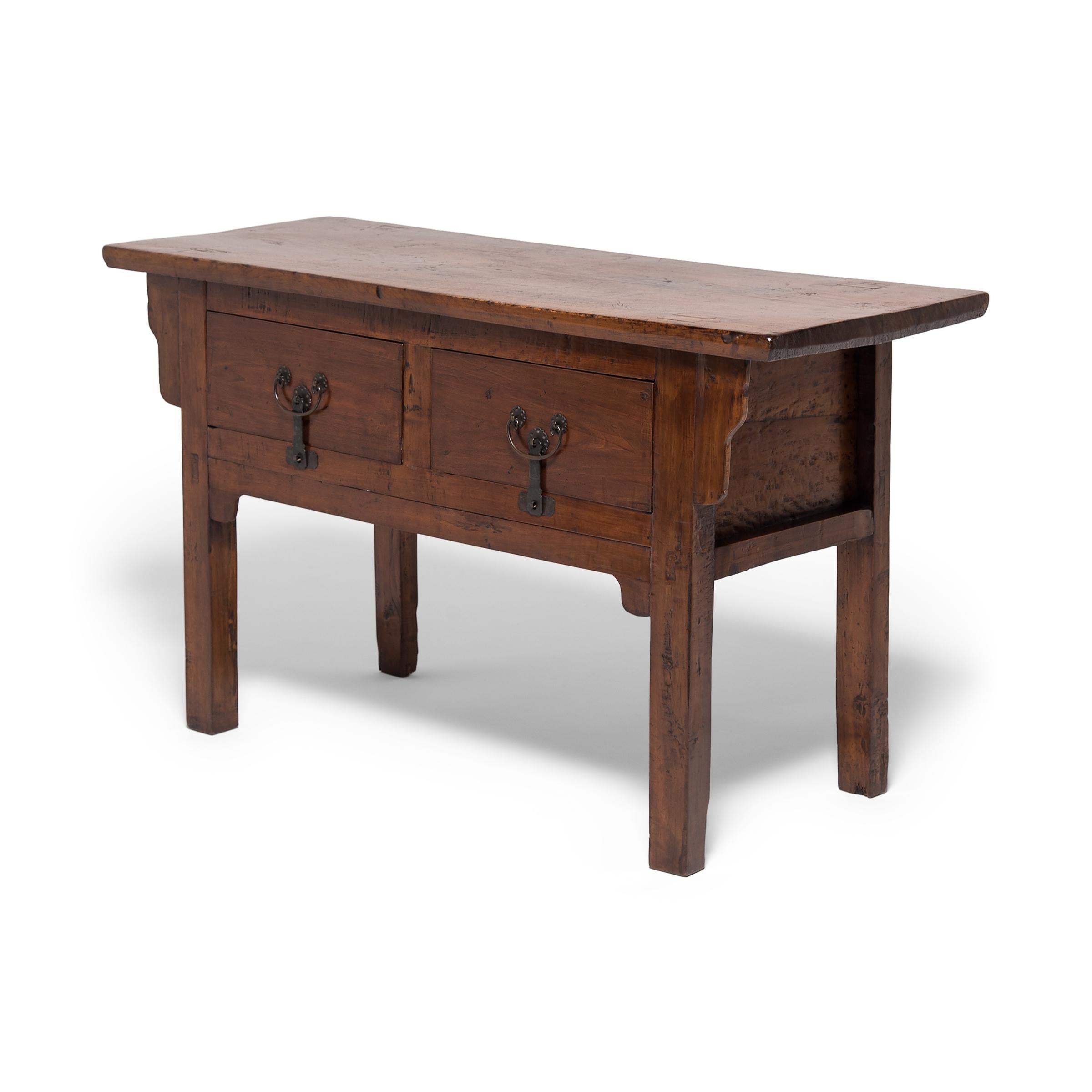 Cloaked in a beautifully aged layer of clear lacquer, this earnest table speaks volumes about simple pride. The console's clean lines and warm, open-grained walnut texture speak to the universal appeal of rustic interiors. Built by an artisan in