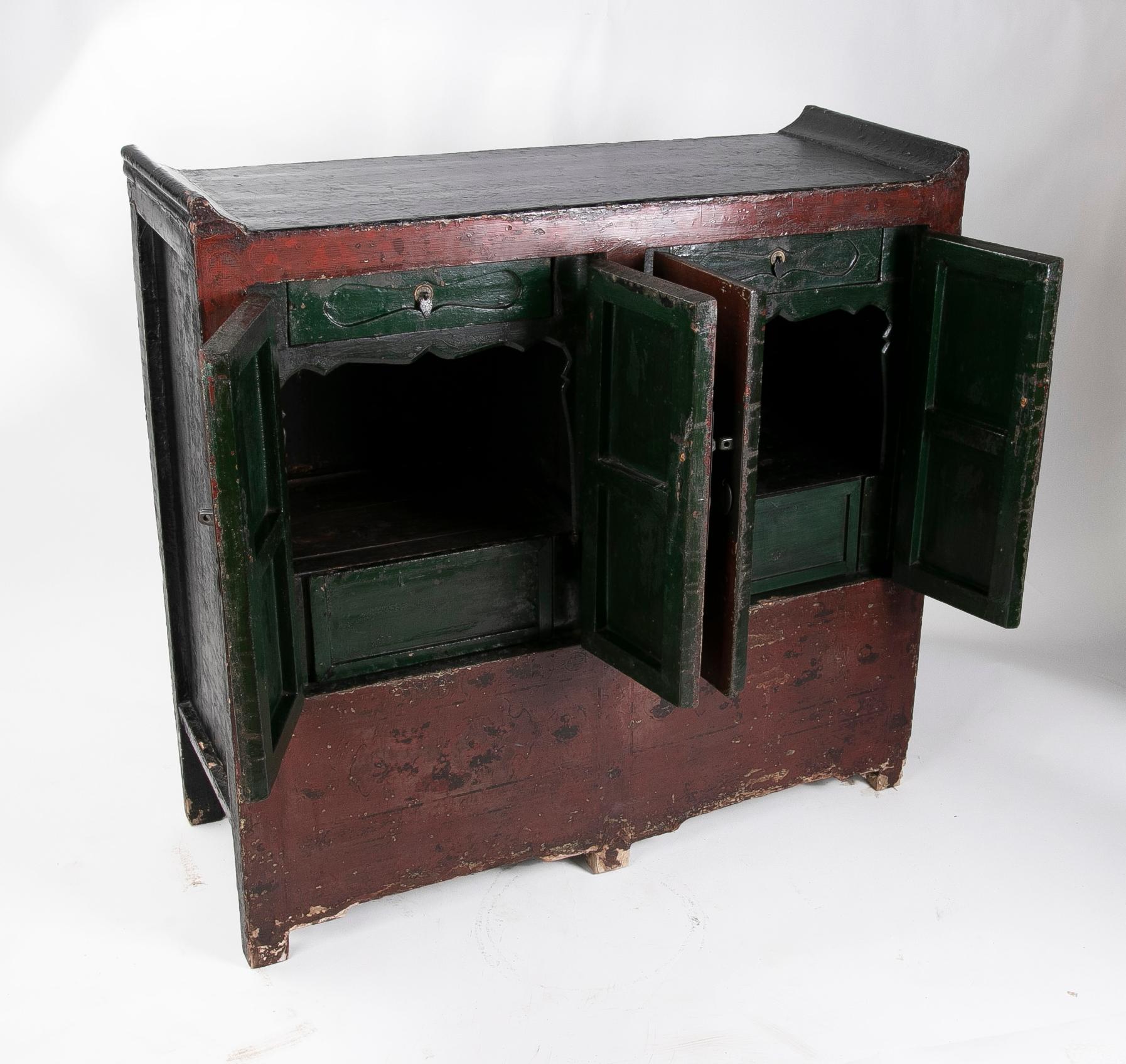 Red lacquered Chinese cupboard with two 19th century doors. Modern iron fittings.