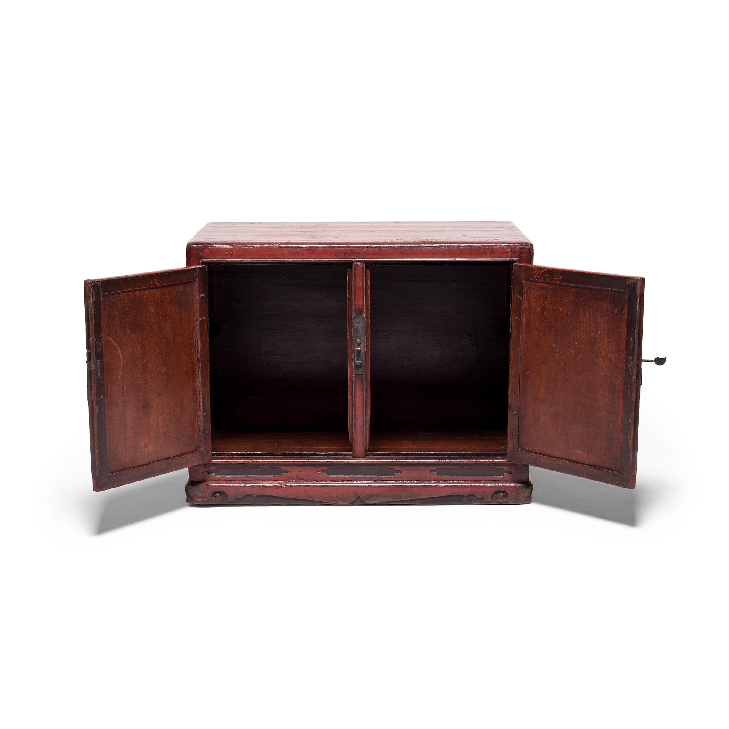A rolled-up scroll or treasured root pot may have once been among the treasured objects stored in this 19th century book chest. Expertly constructed in China's Shanxi province, the low cabinet exemplifies the clean lines of Ming-dynasty forms. Layer