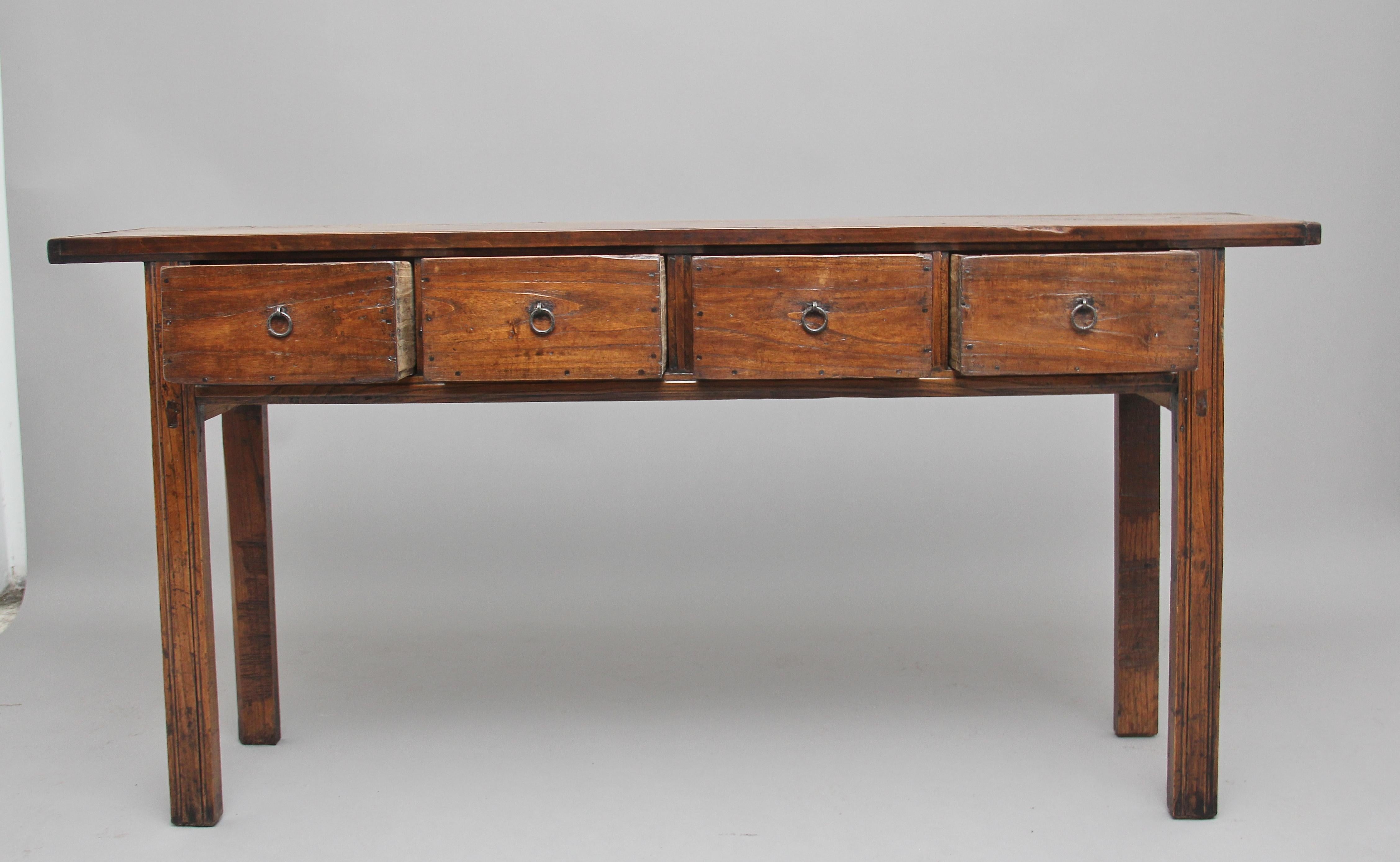 19th century Chinese elm dresser base / serving table, having a nice rustic rectangular top above four-drawers with original brass ring pull handles, supported on four square legs. Lovely color and in fantastic condition, circa 1880.
