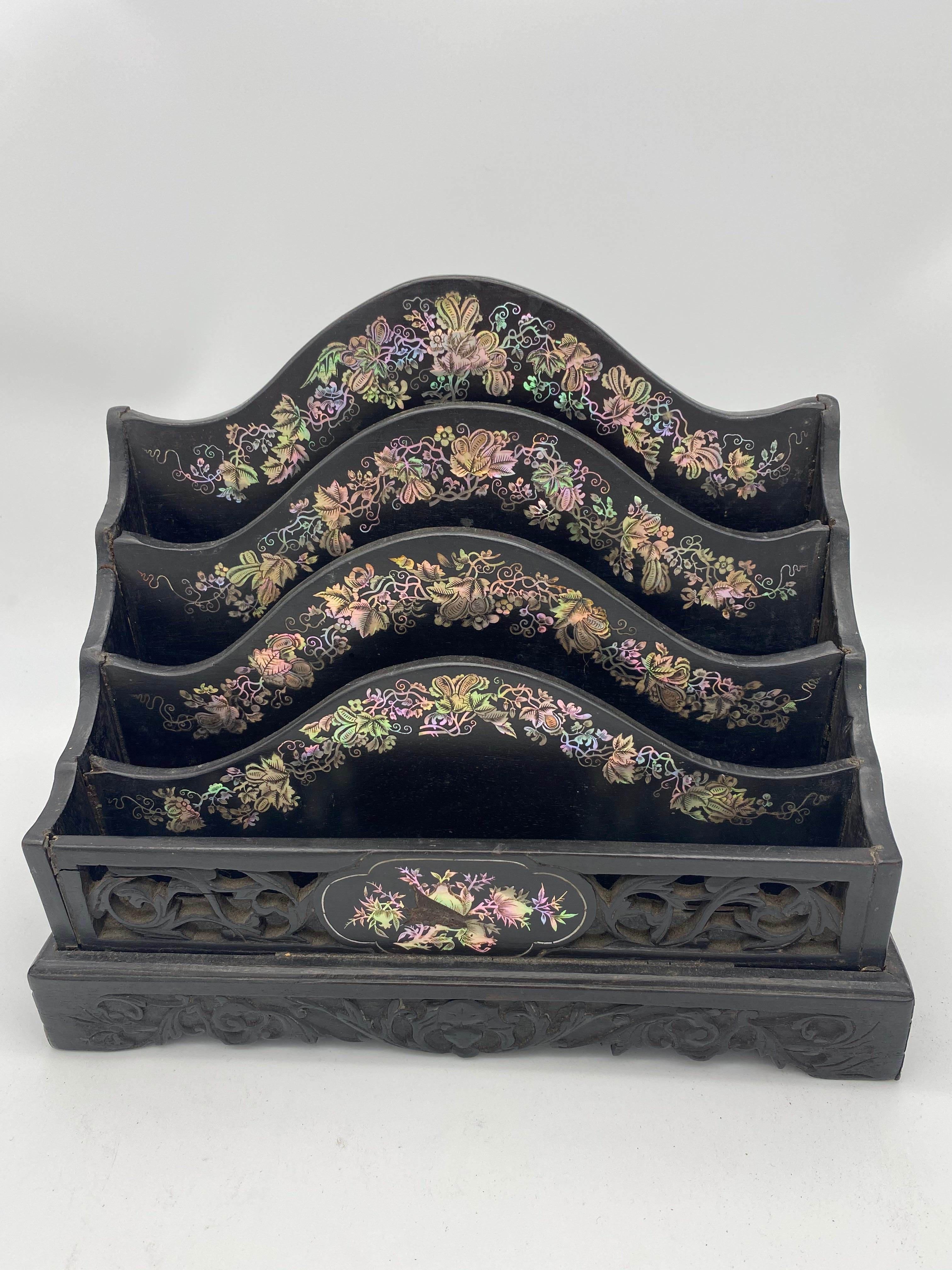 19th century Chinese ebonized letter rack with mother of pearl from the Qing dynasty. Beautiful mother of pearl of four divisional arched form above a scrolled leaf fret-cut frieze and carved cutout base 31ch wide, 16cmd deep, 26cm high.