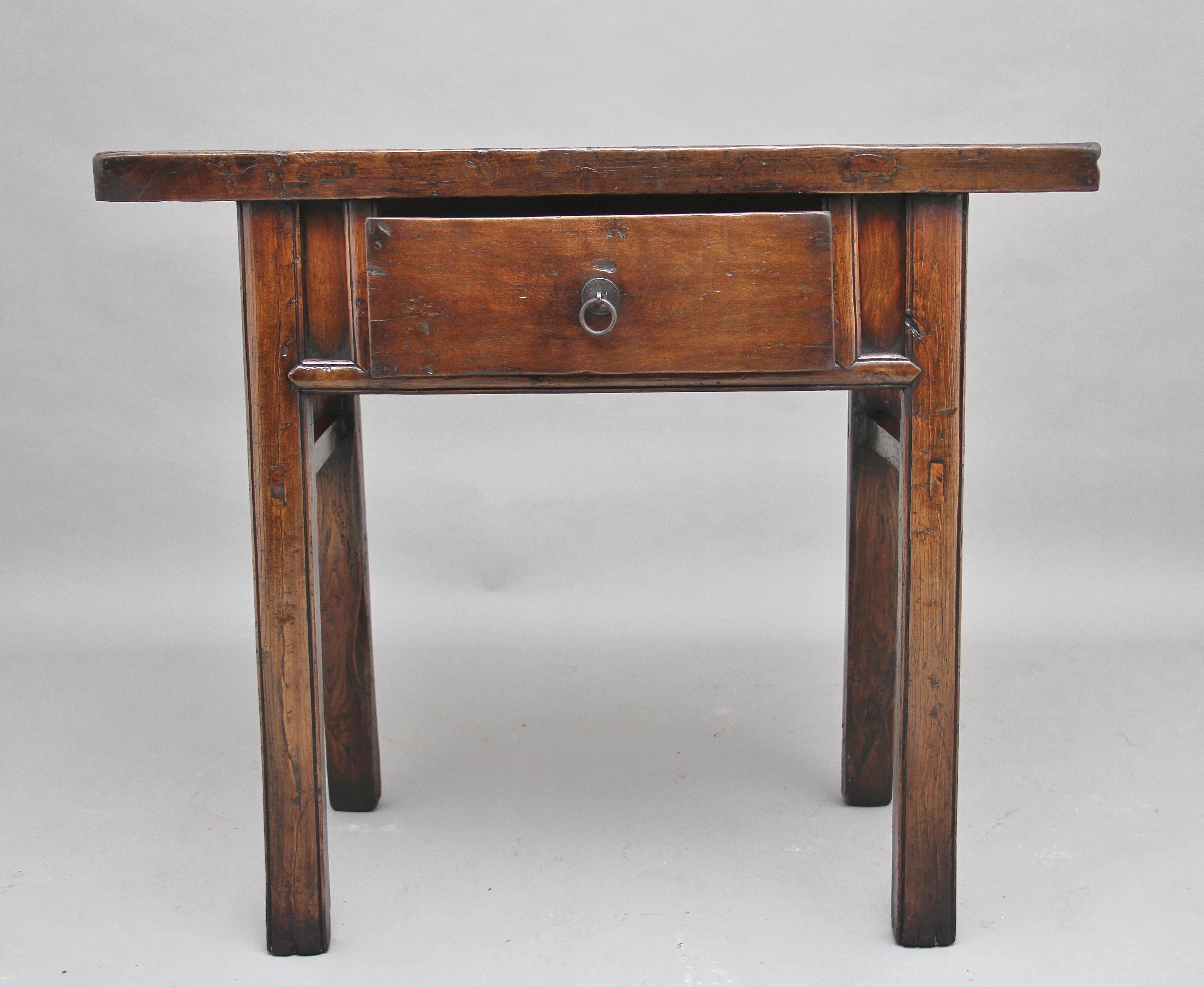 19th century Chinese elm side table with a nice rustic looking top above a single drawer with original brass ring handle, standing on square legs united with side stretchers. Lovely color and in excellent condition, circa 1880.