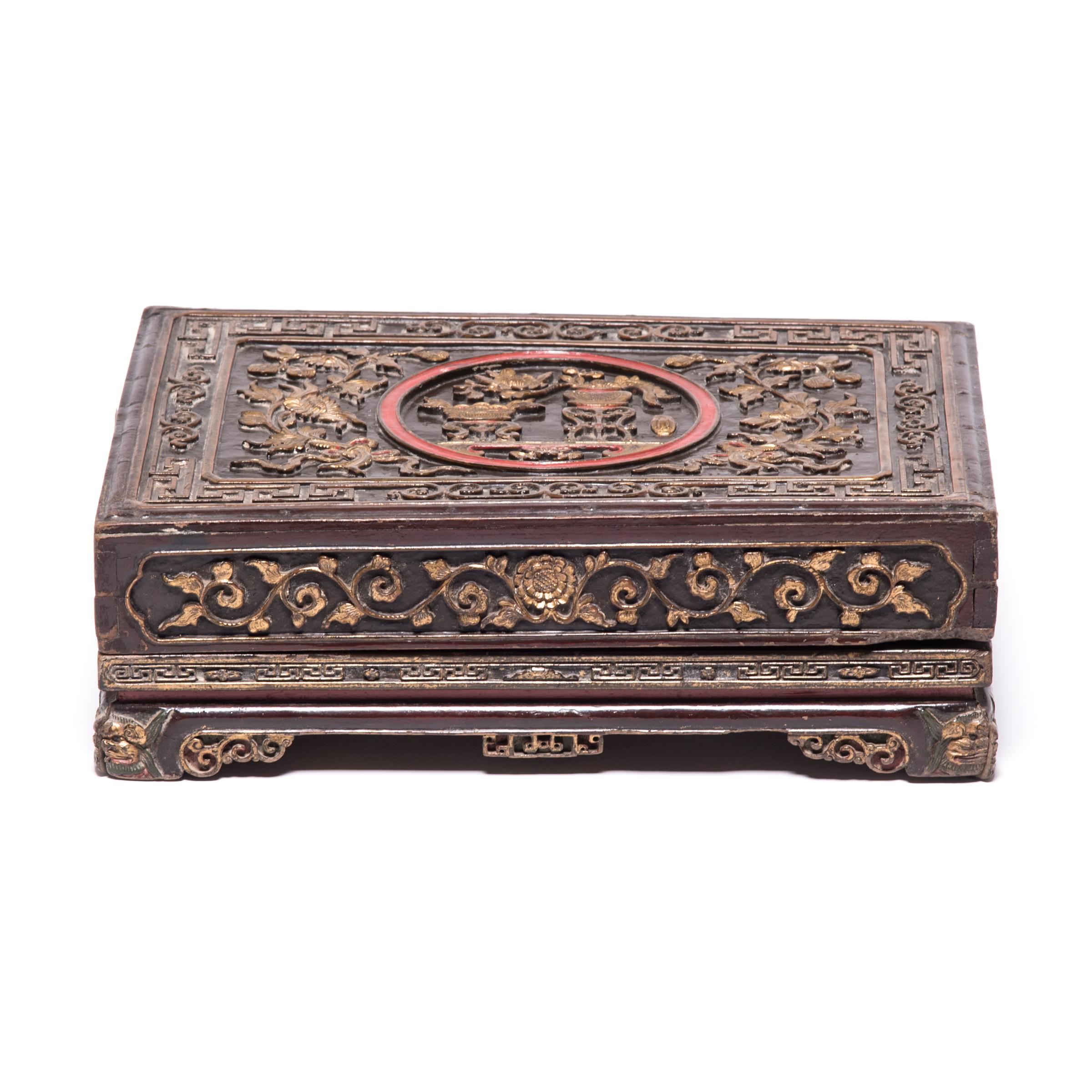 This ornately carved 19th-century offering box would have been presented as a gift filled with popular Chinese snacks, including roasted melon seeds, dried fruit, and soybeans toasted with cinnamon, fennel, and other spices. Offering fruits, floral