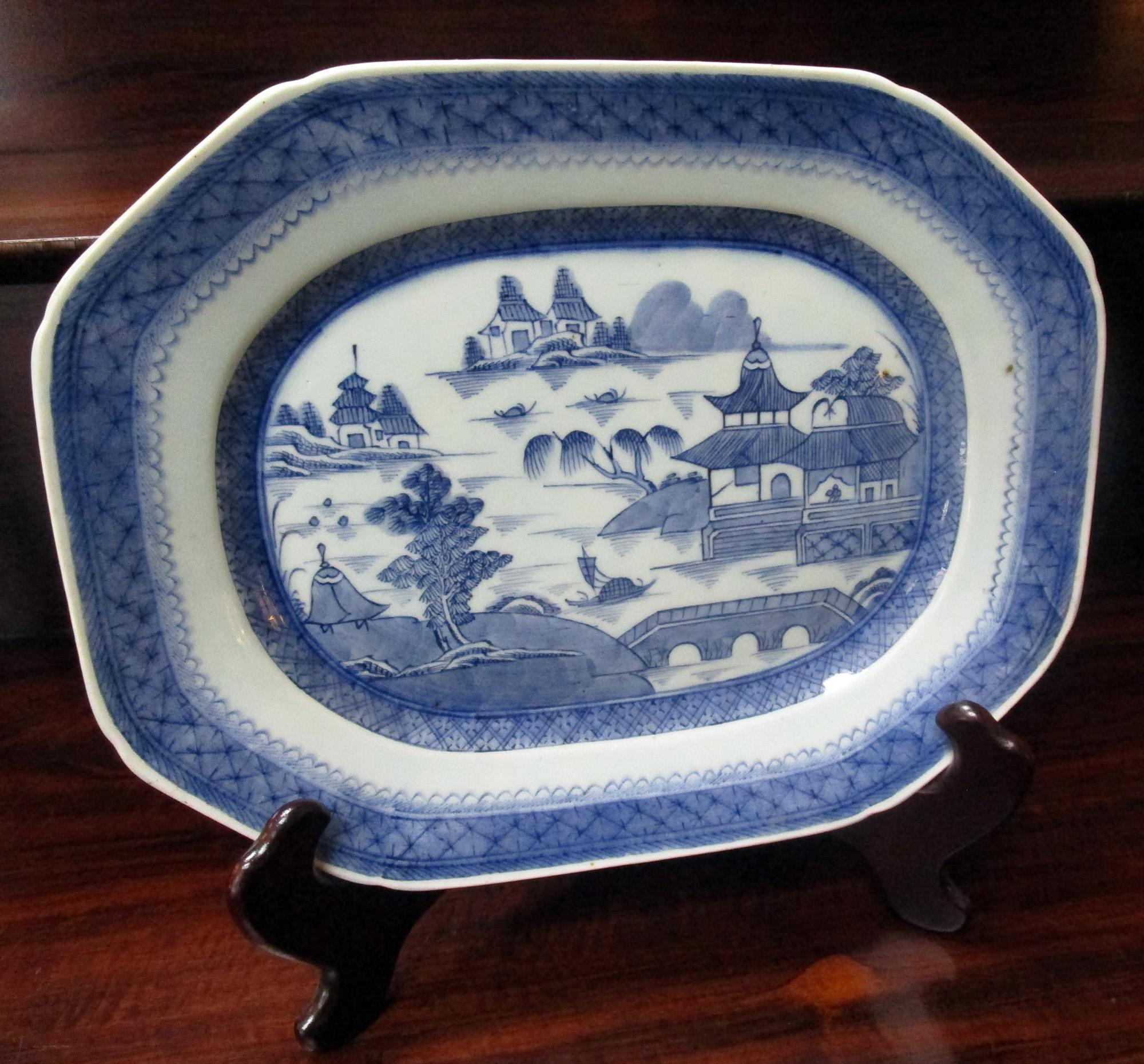 Antique 19th century canton octagonal shaped platter decorated in an under-glazed blue with a traditional Chinese hand decoration set against a white porcelain background. The bottom rim of the platter is unglazed. Good condition with some residue