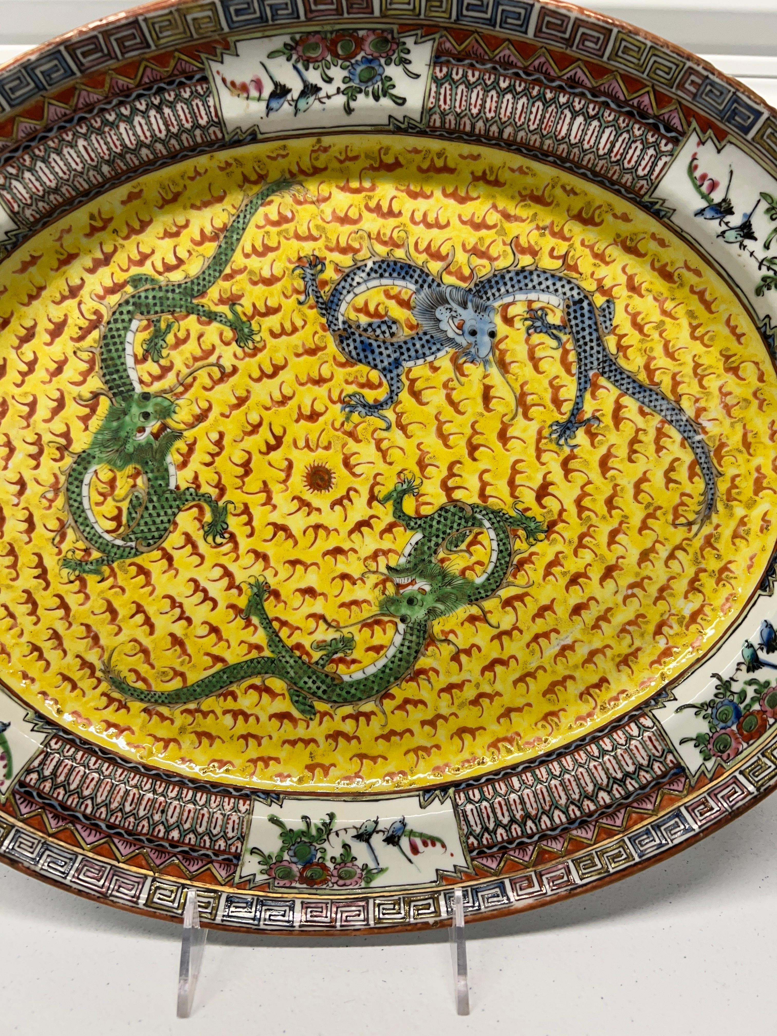 Chinese, early to mid 19th century.

An antique famille jaune platter decorated with 3 imperial dragons chasing the central pearl. A good quality enameled edge with greek key style bordering. Marked to the unglazed bottom 
