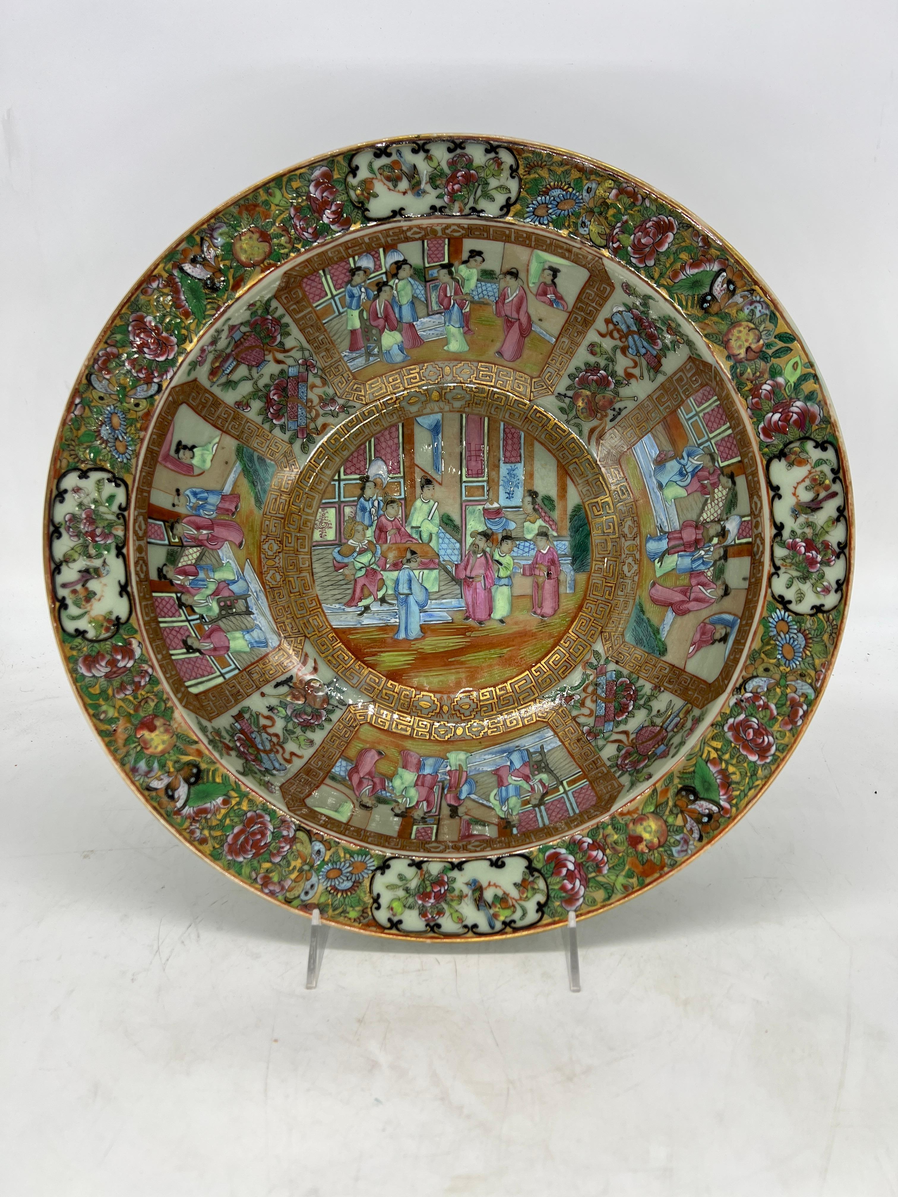 Chinese, 19th century.

A fine quality antique Chinese famille rose medallion wash basin or centerpiece bowl. The center has a vivid immortal courtyard scene surrounded by a greek key border and 4 matching windows to the interior edge. The border