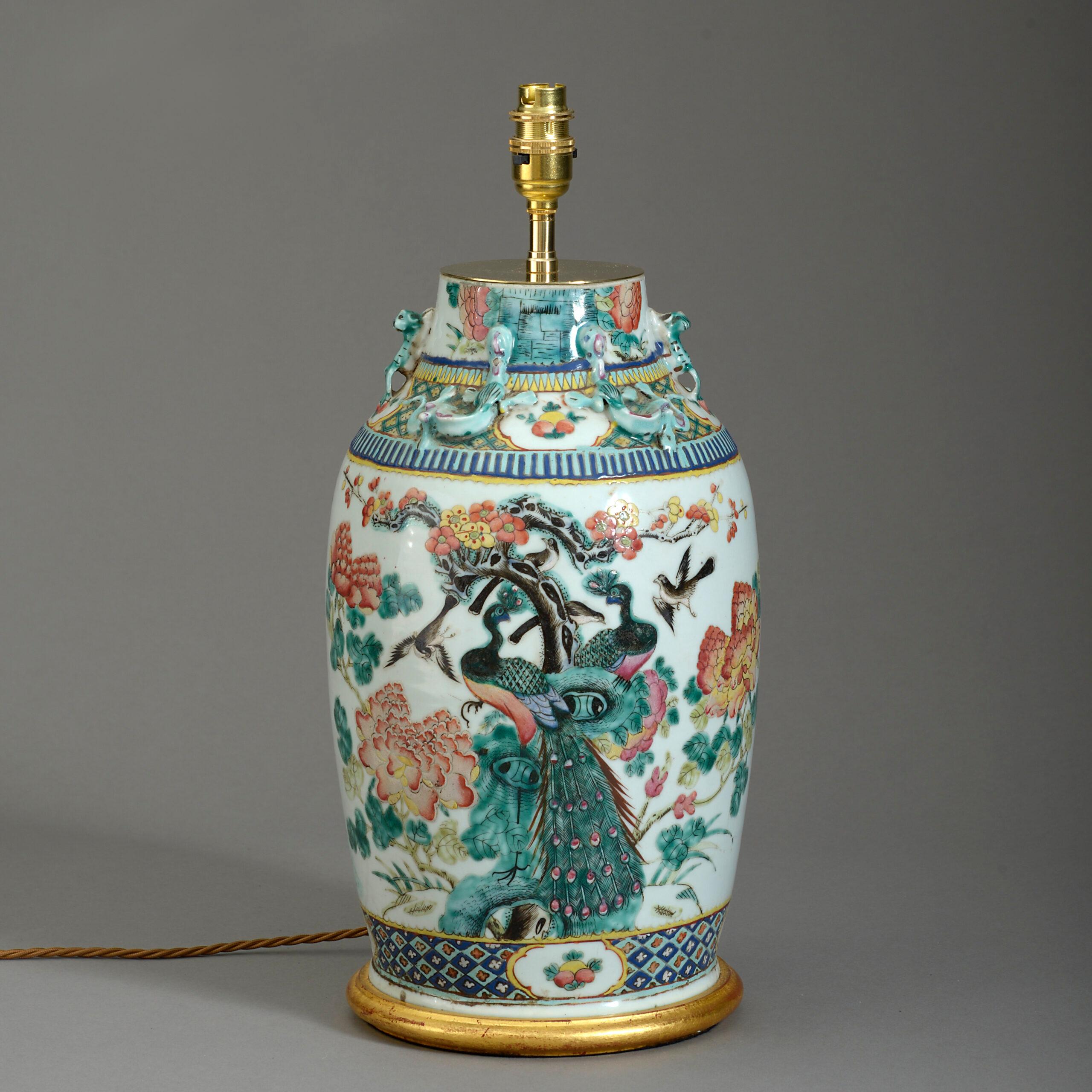 A mid-nineteenth century famille verte porcelain vase of good scale, decorated throughout with exotic birds, flowers and foliage. Now mounted as a lamp base upon a turned giltwood base. The neck reduced in height.

Dimensions refer to vase and