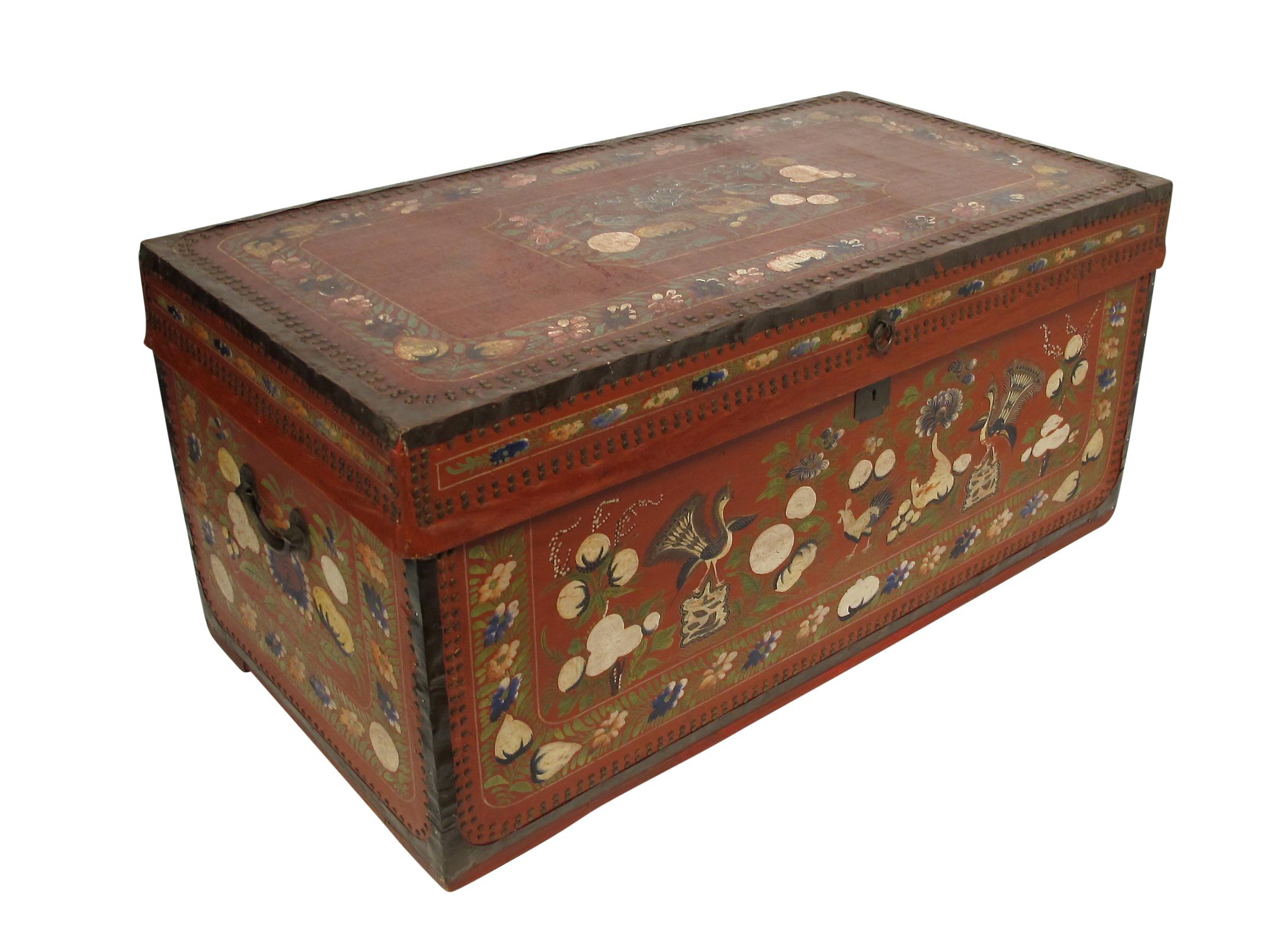 A red pig skin leather trunk with hand-painted floral decoration and having nailhead trim. China, mid-19th century.