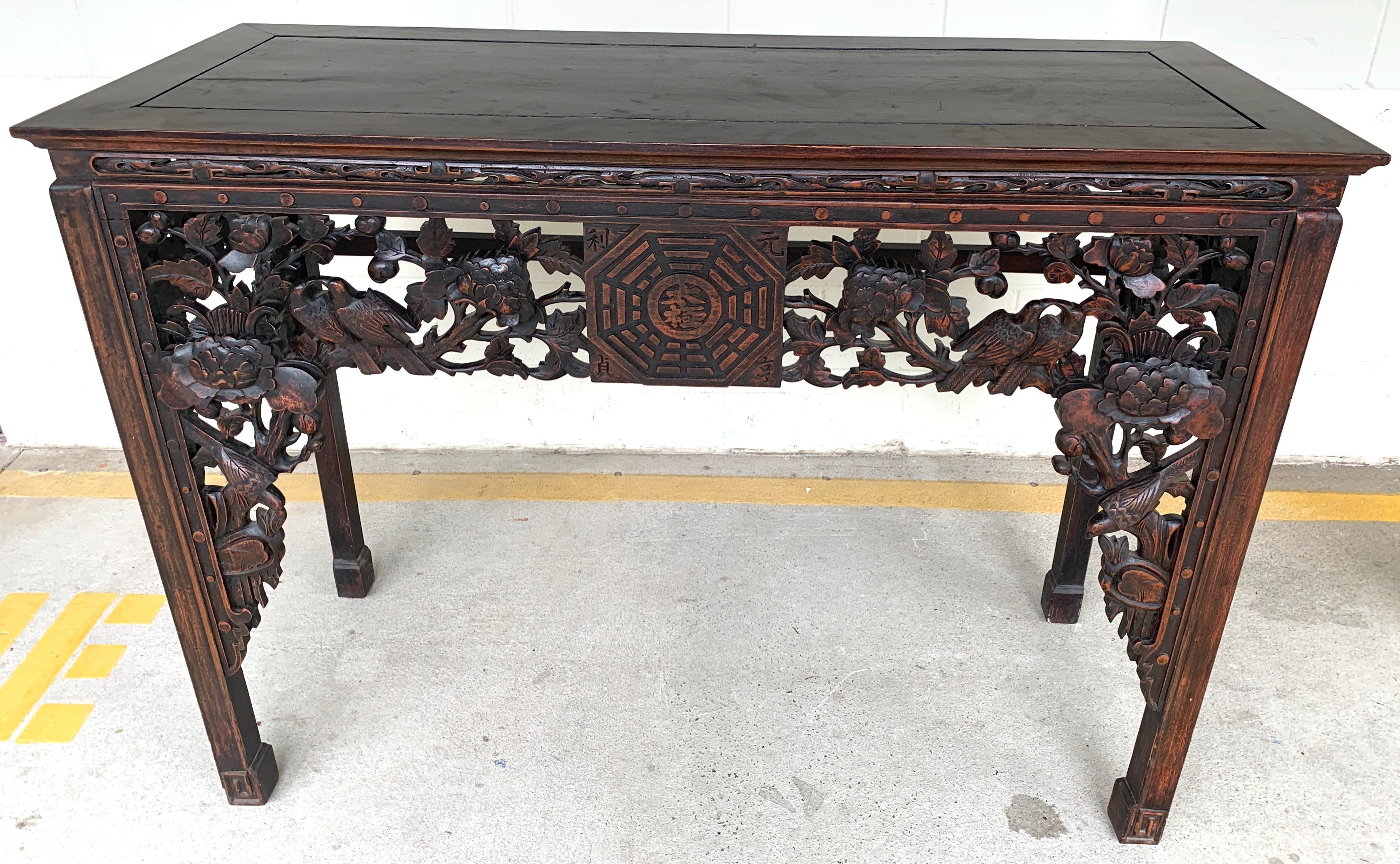 19th century Chinese export hardwood altar table, of rectangular form, with finely carved pierced front and sides with birds and foliage with central Chinese’s medallion.