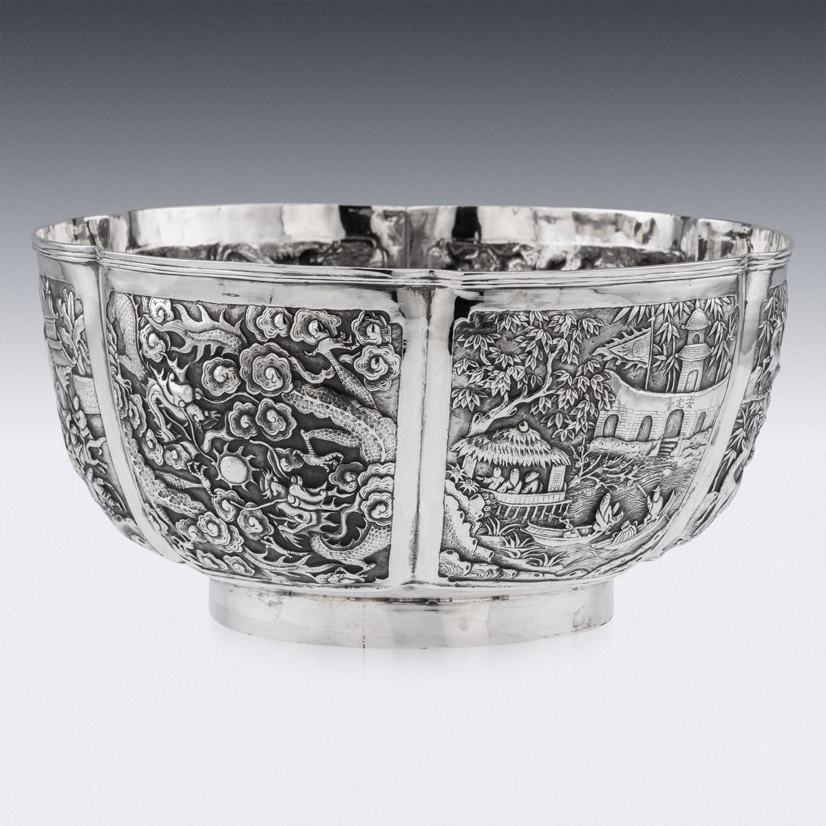 Antique late-19th century Chinese export solid silver very large bowl, of exceptionally fine quality and impressive size, intricately chased and embossed depicting a compendium of various designs and themes, six shaped panels depicting a battle