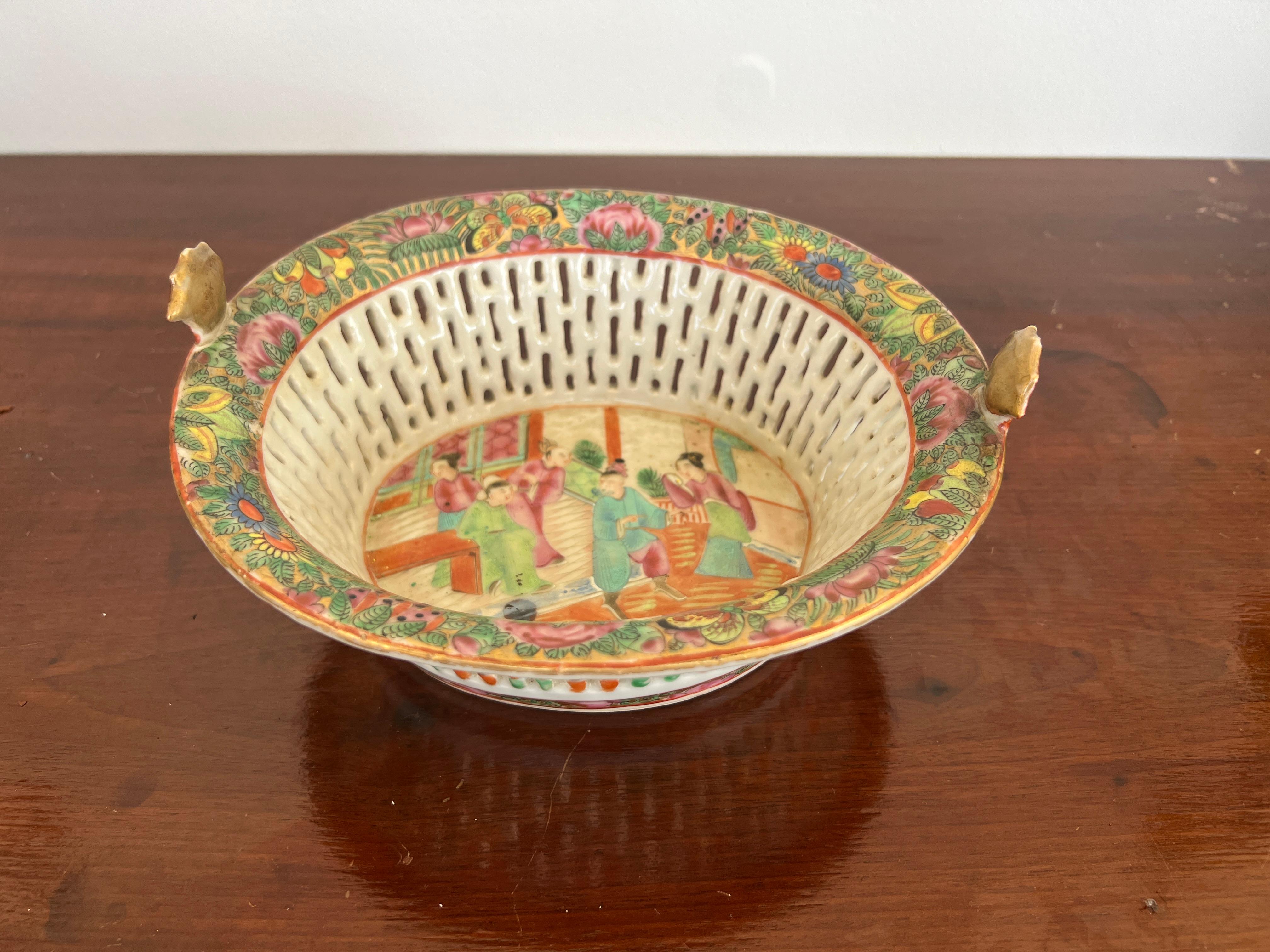 Chinese, 19th century.

An antique Chinese export porcelain chestnut basket. The basket features traditional famille rose medallion decoration with figural window to the central window. Butterfly motifs to the exterior edge forming into small red